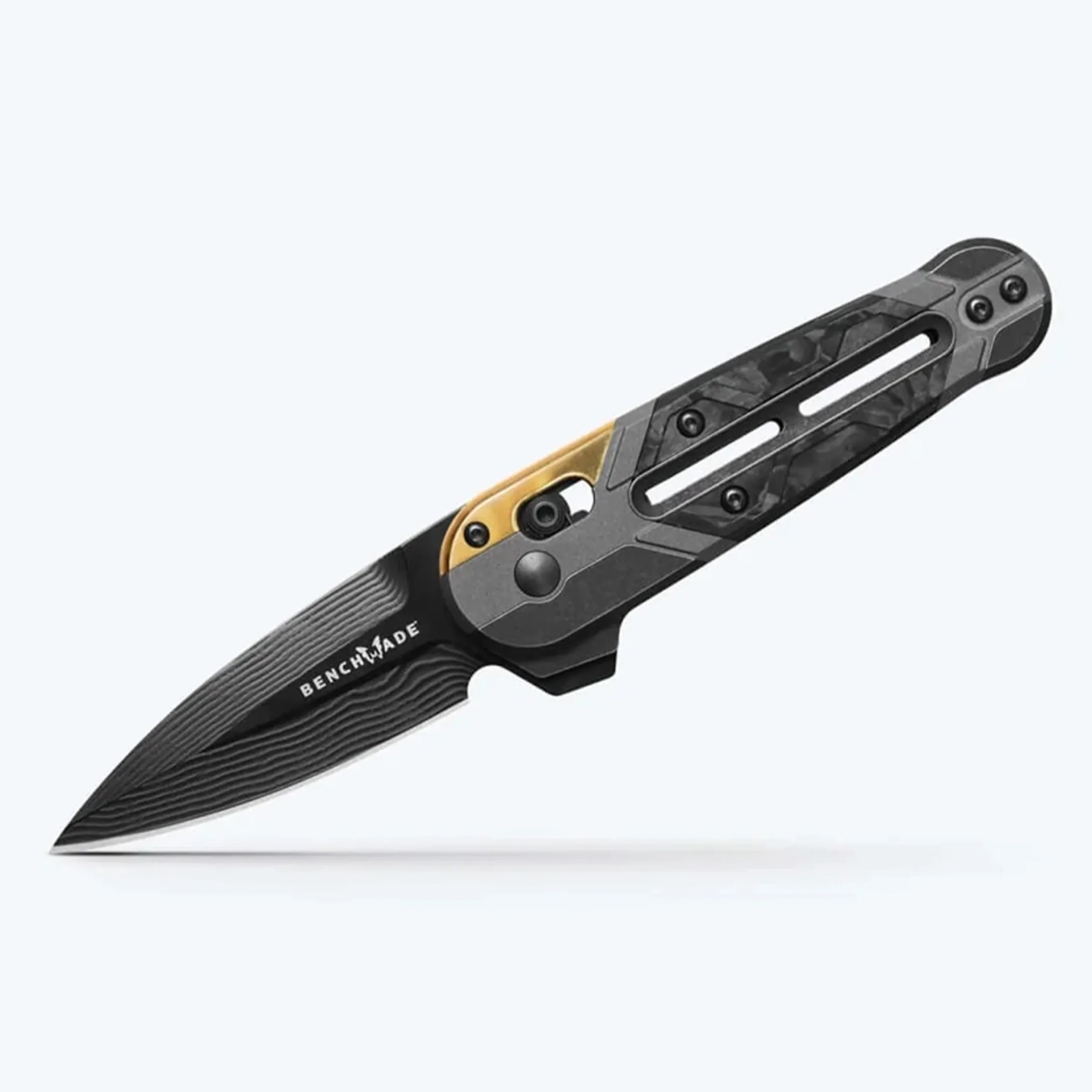 Black Benchmade folding knife with textured handle and gold-colored clip.