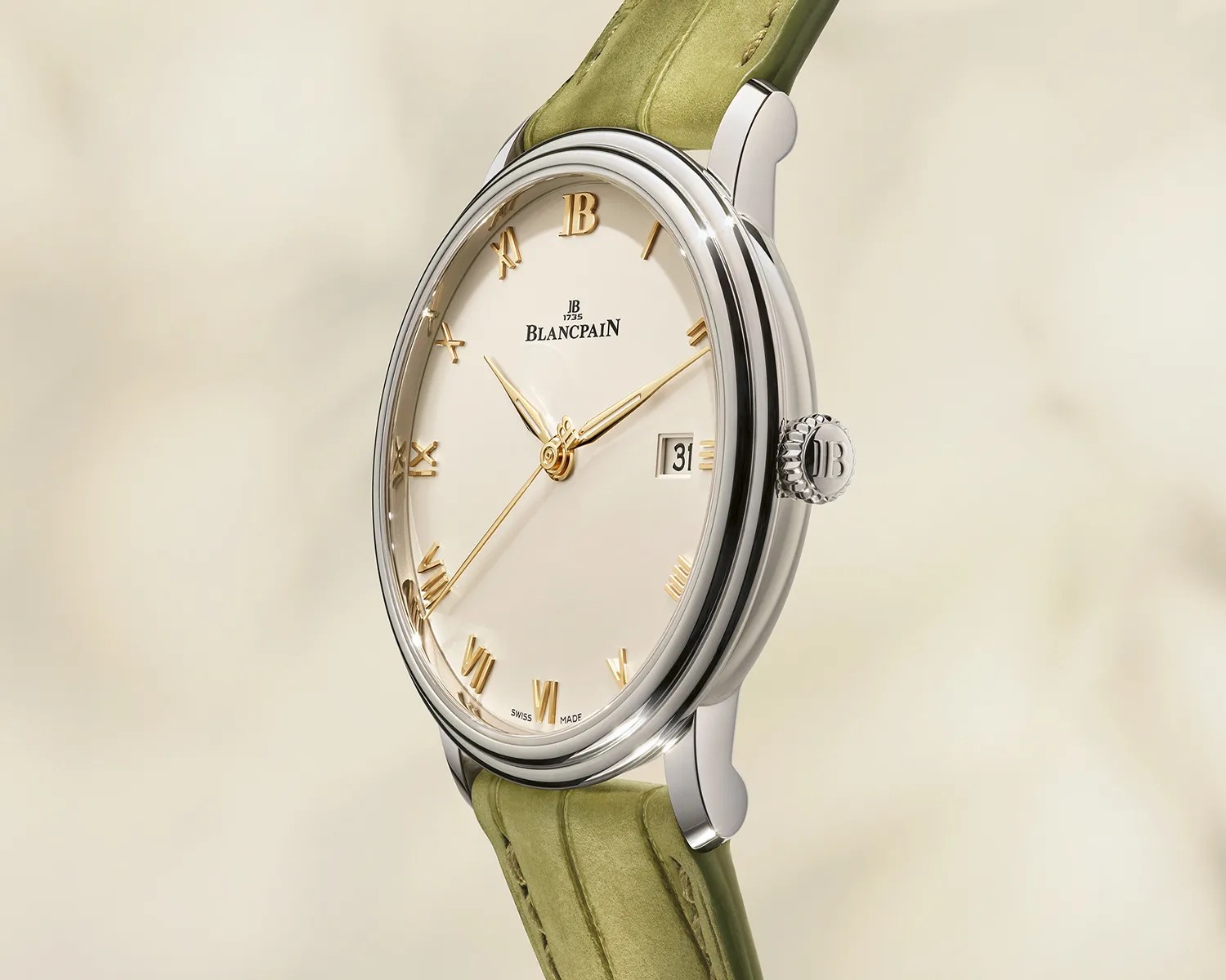 Silver Blancpain wristwatch with gold Roman numerals, white dial, date window, and green leather strap.