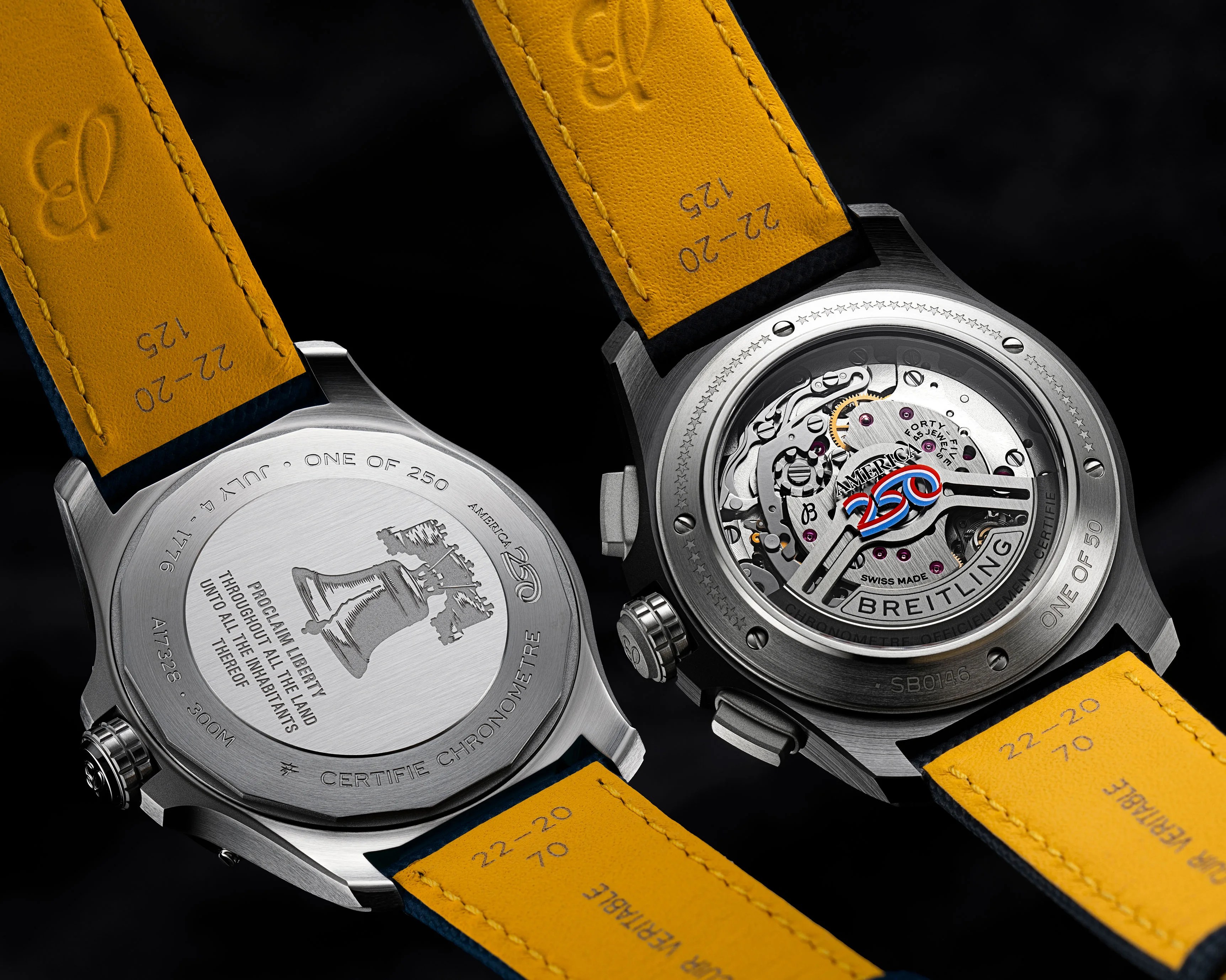 Two Breitling watch backs with yellow leather straps, one showing engraved Liberty Bell and text, the other showing mechanical movement with "America 250" logo.