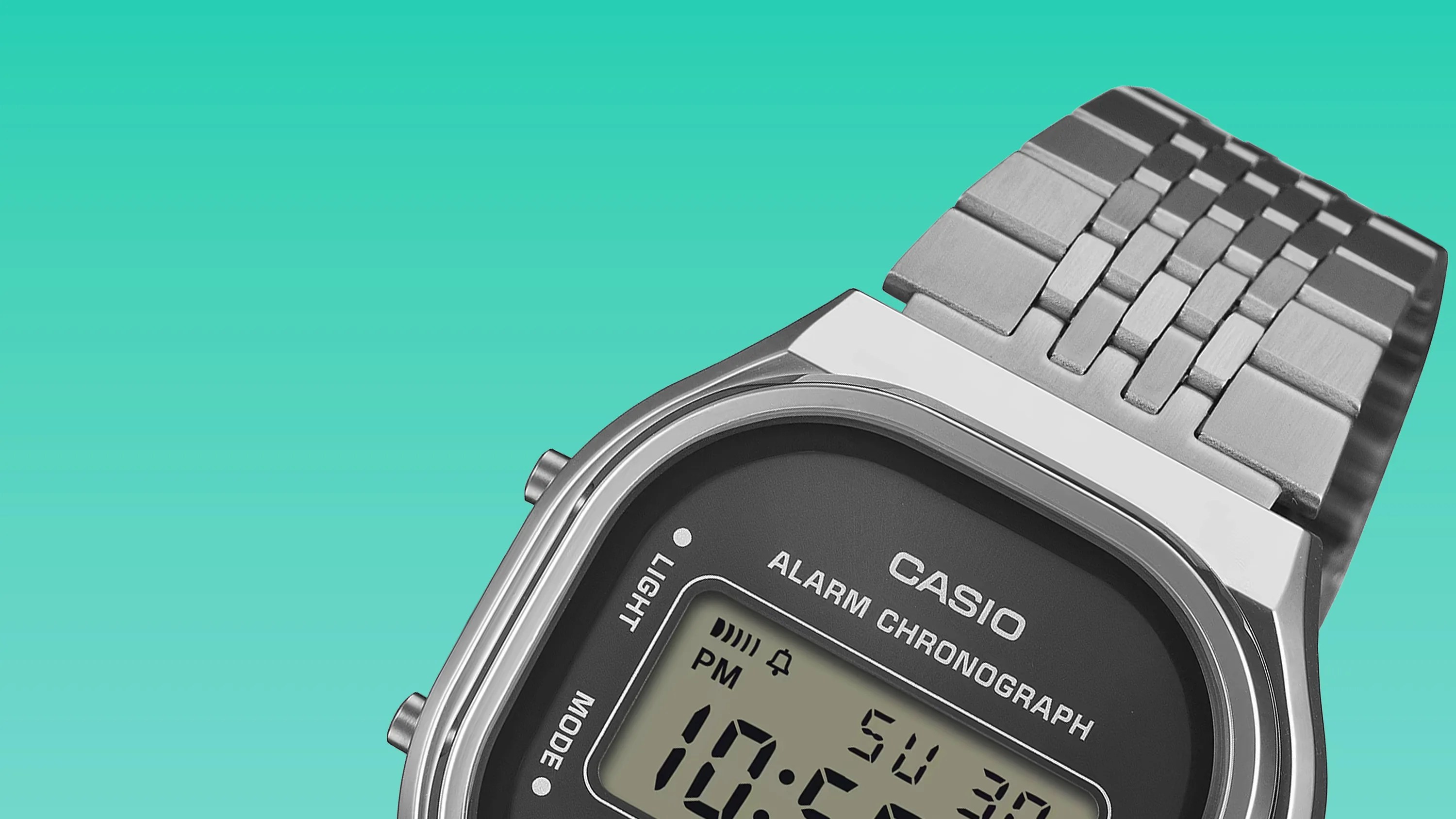 Close-up of a silver Casio digital watch with a metal link band on a turquoise background.
