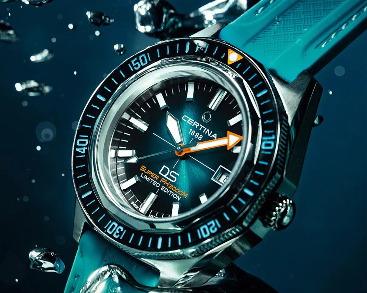 Close-up of a Certina DS Super PH200M limited edition dive watch with a blue dial and turquoise rubber strap underwater.
