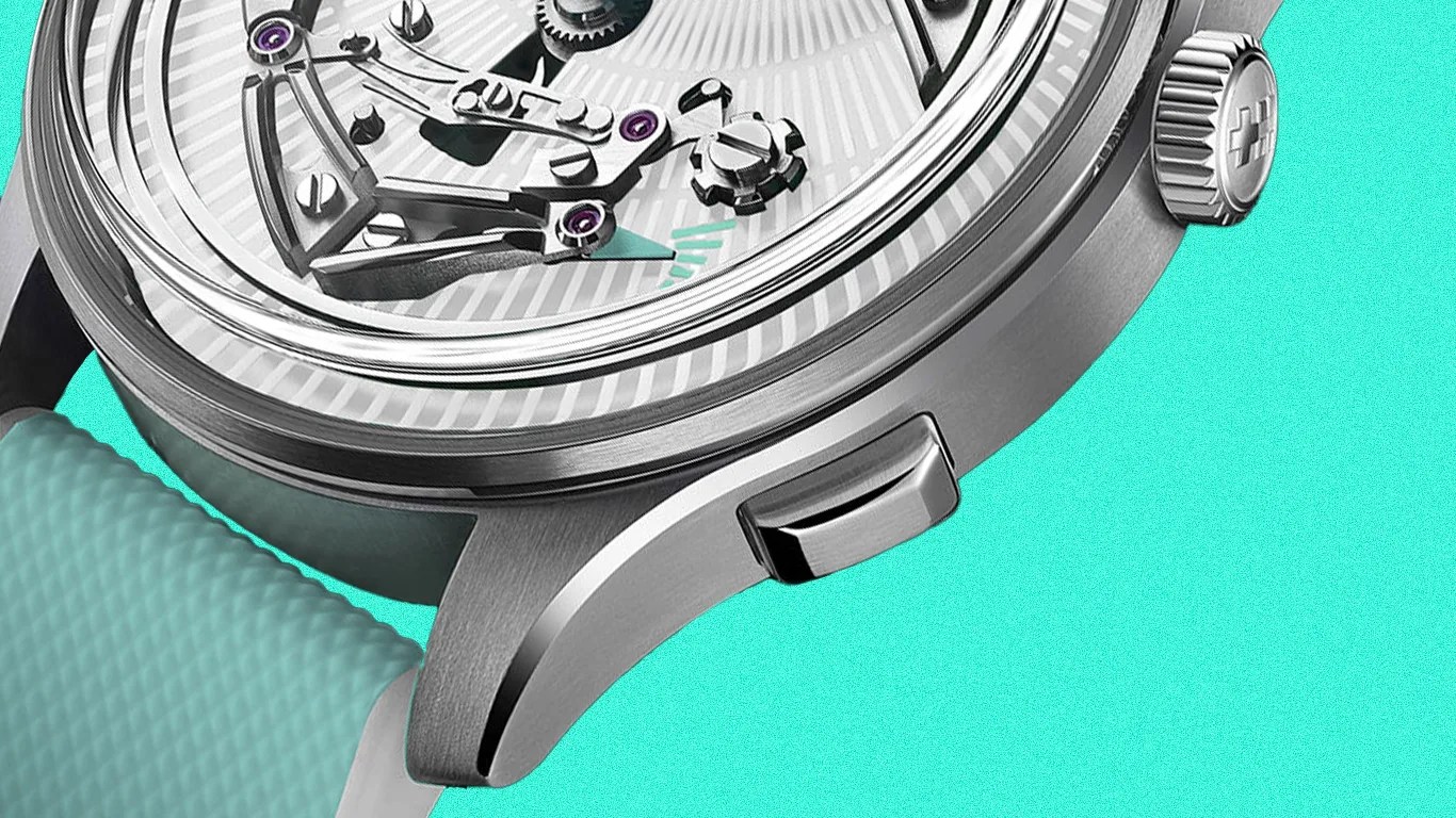 Close-up of a silver mechanical watch case with a textured turquoise rubber strap and visible gears under a clear crystal.