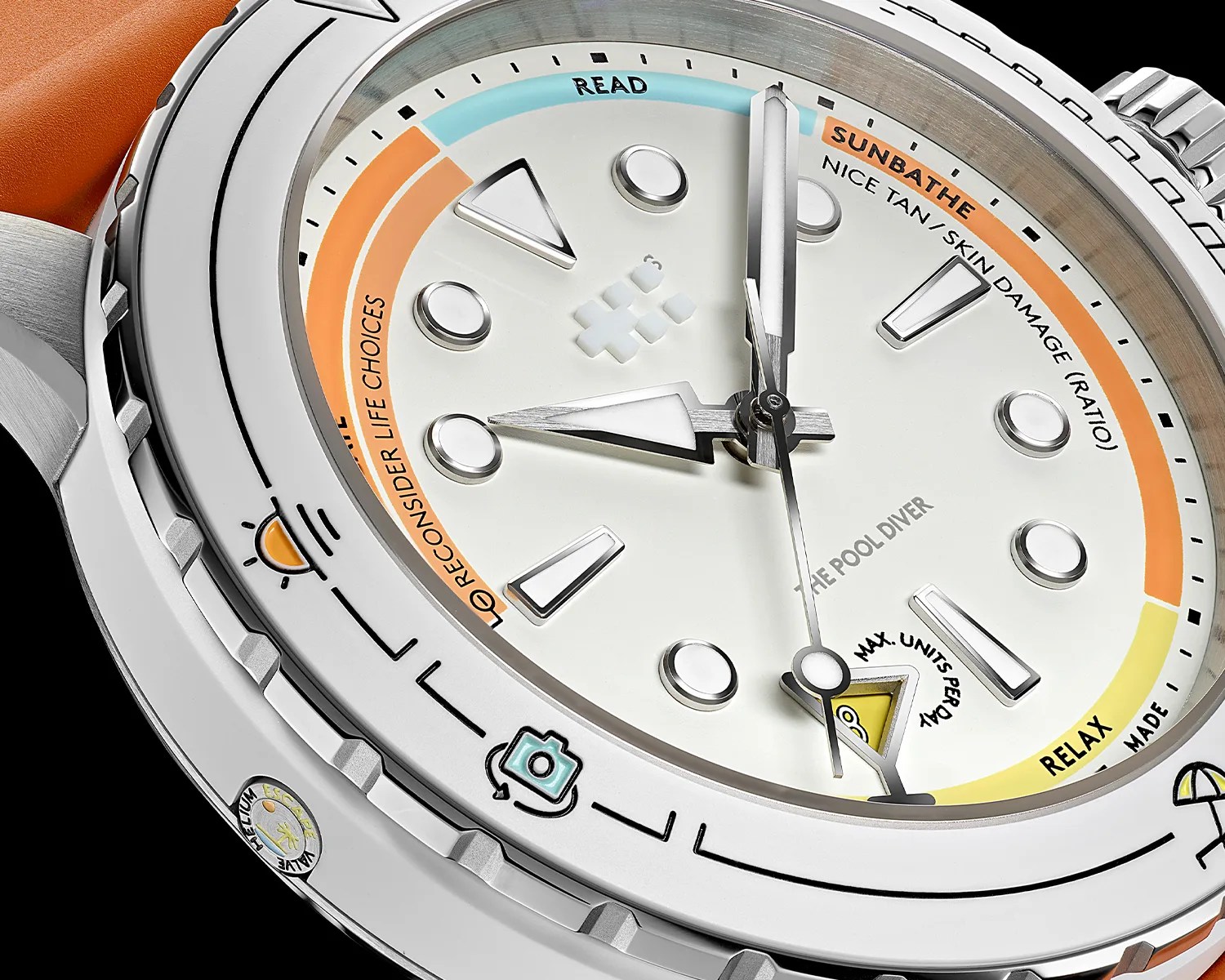 Close-up of a silver dive watch with a white dial, orange leather strap, and colorful sections labeled "READ," "SUNBATHE," "RECONSIDER LIFE CHOICES," and "RELAX.