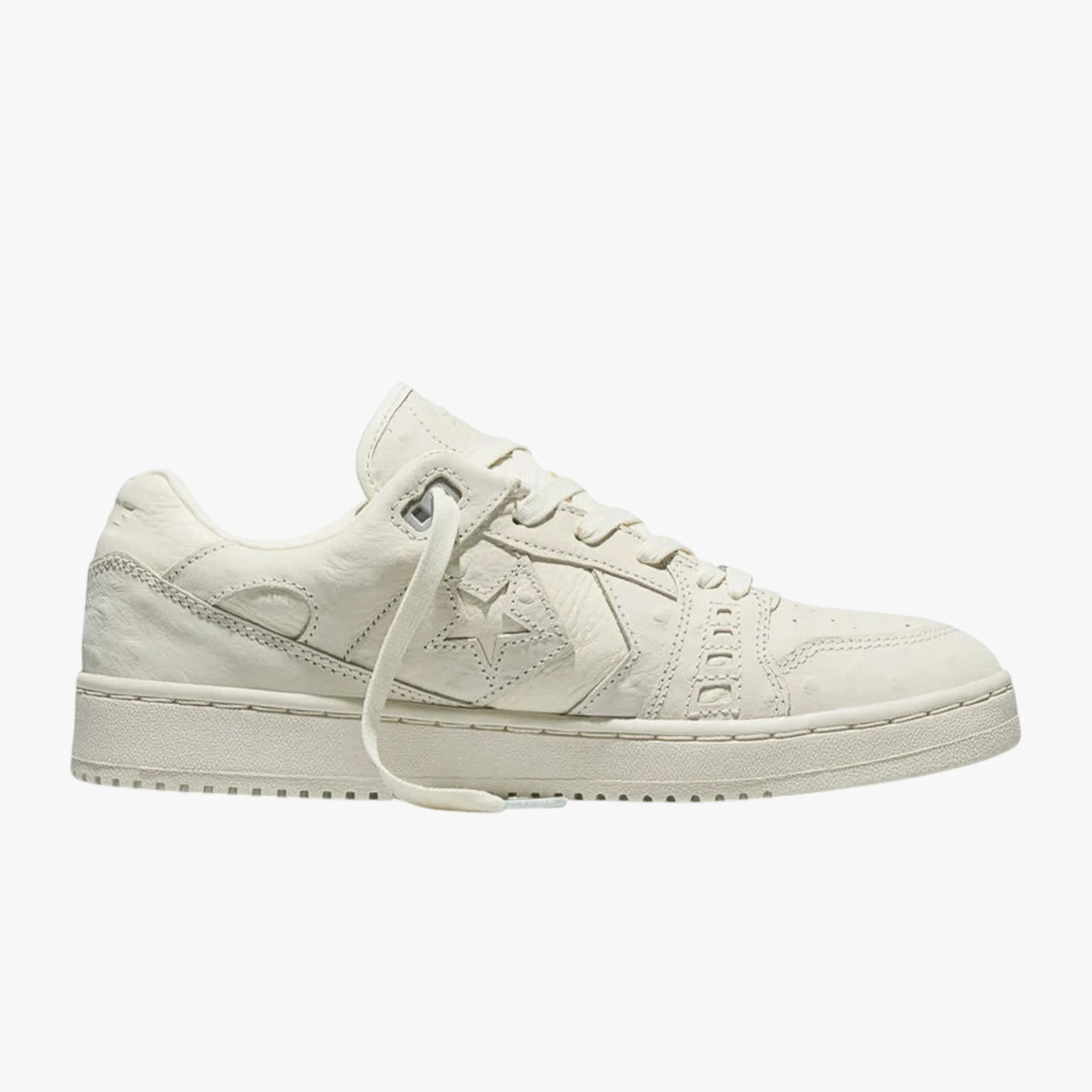 Off-white leather low-top sneaker with star logo and thick sole.