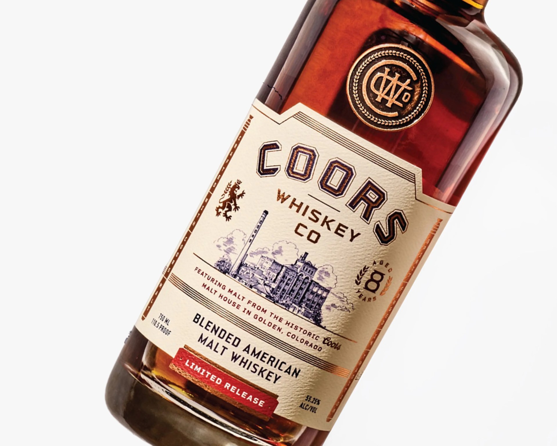 Amber whiskey bottle labeled "Coors Whiskey Co" with a vintage-style label showing a distillery and "Blended American Malt Whiskey.