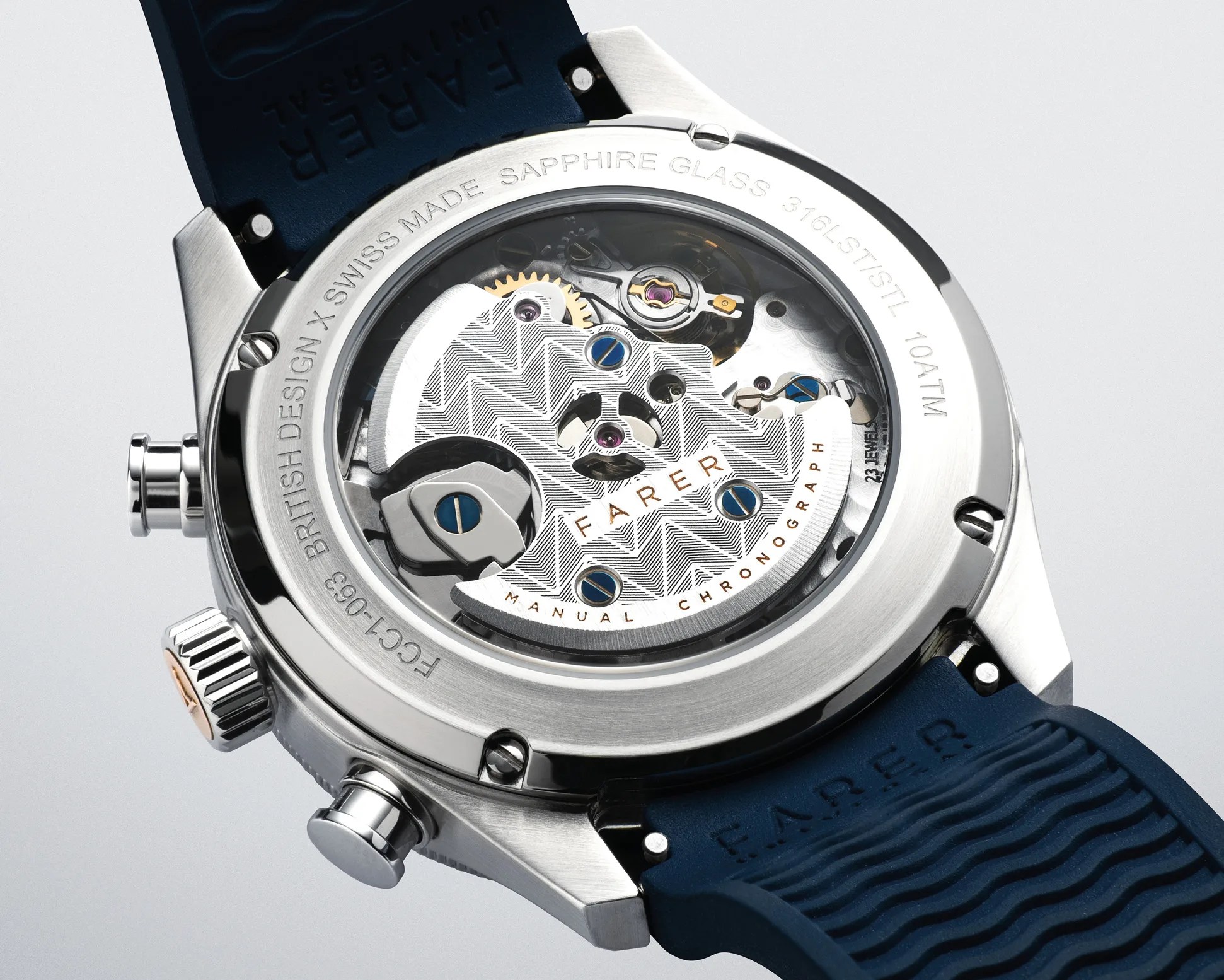 Close-up of a silver watch case back showing intricate mechanical movement with blue screws and a blue rubber strap.