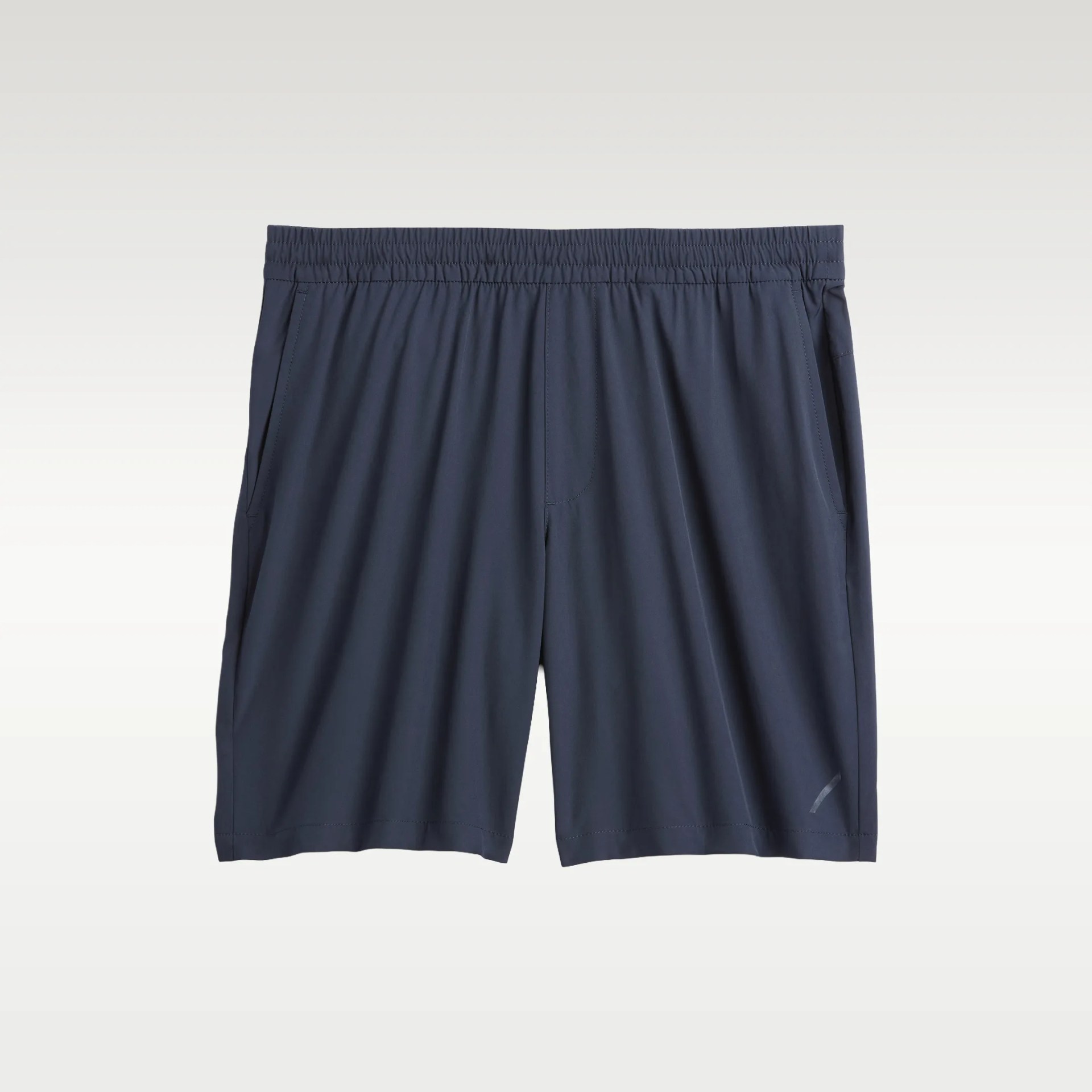 Navy blue athletic shorts with elastic waistband and side pockets on a light background.