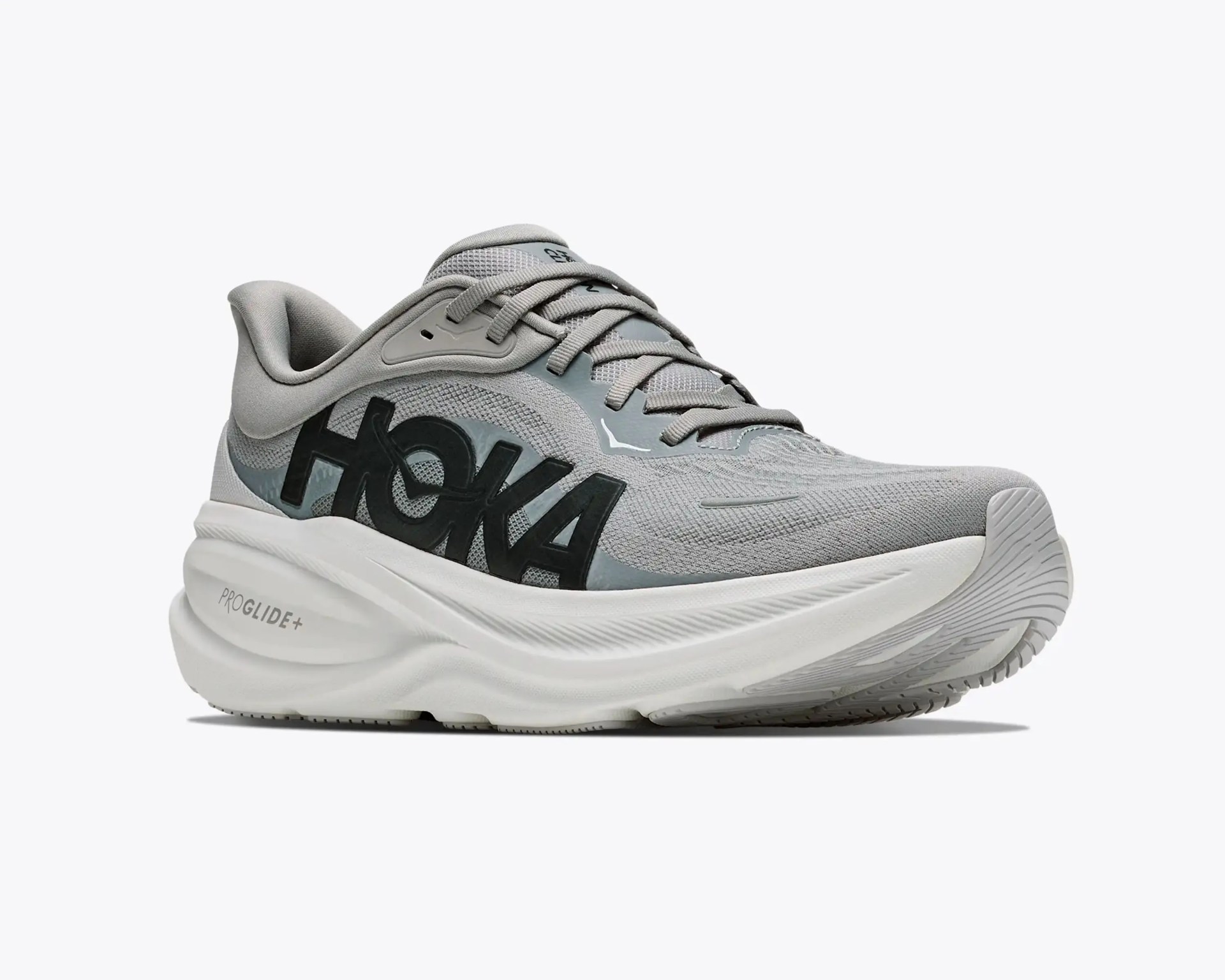 Gray HOKA running shoe with thick white sole and "PROGLIDE+" text on the midsole.