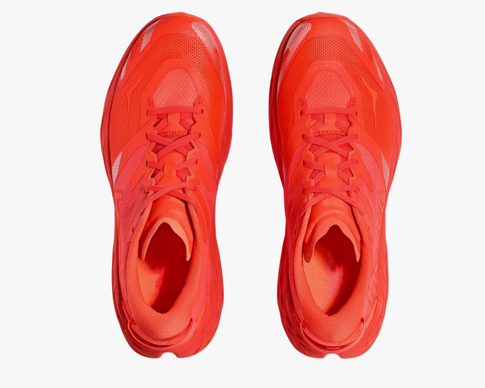 Pair of bright red athletic shoes viewed from above on a white background.
