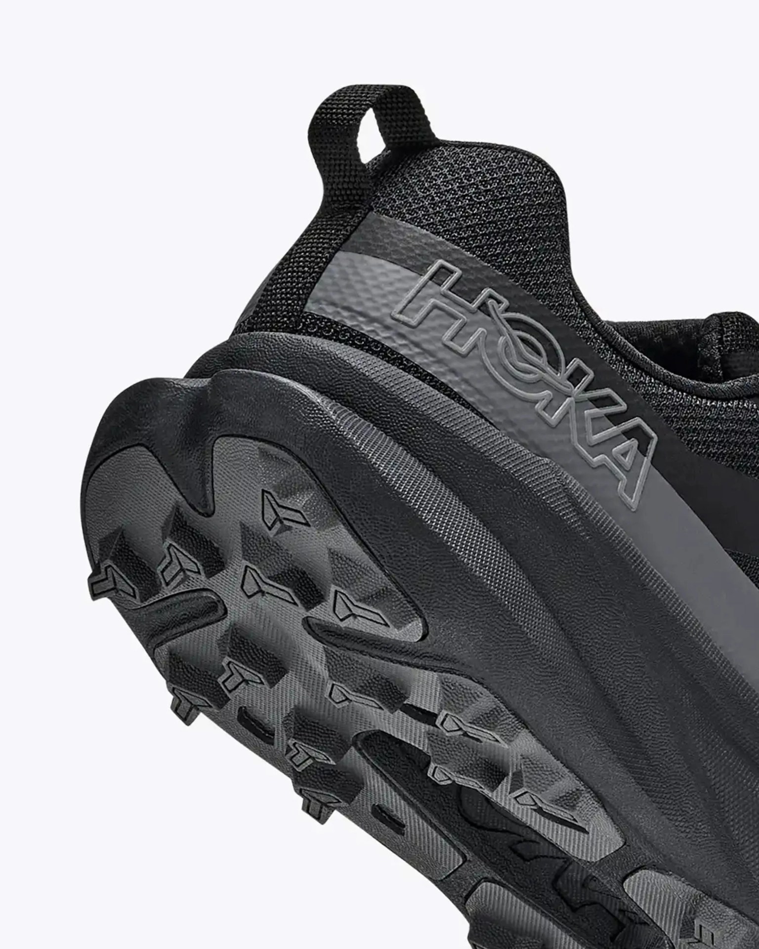 Black Hoka trail running shoe with textured sole and pull tab at heel.