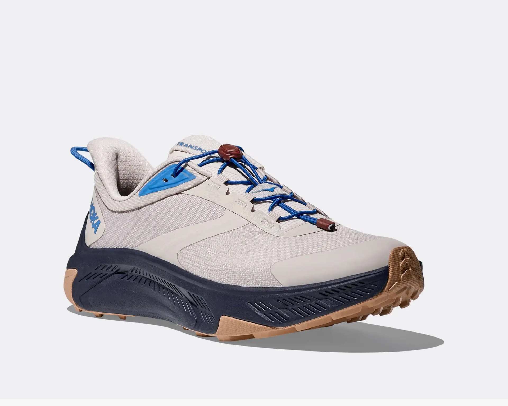 Light gray and blue trail running shoe with blue elastic laces and gum rubber outsole.
