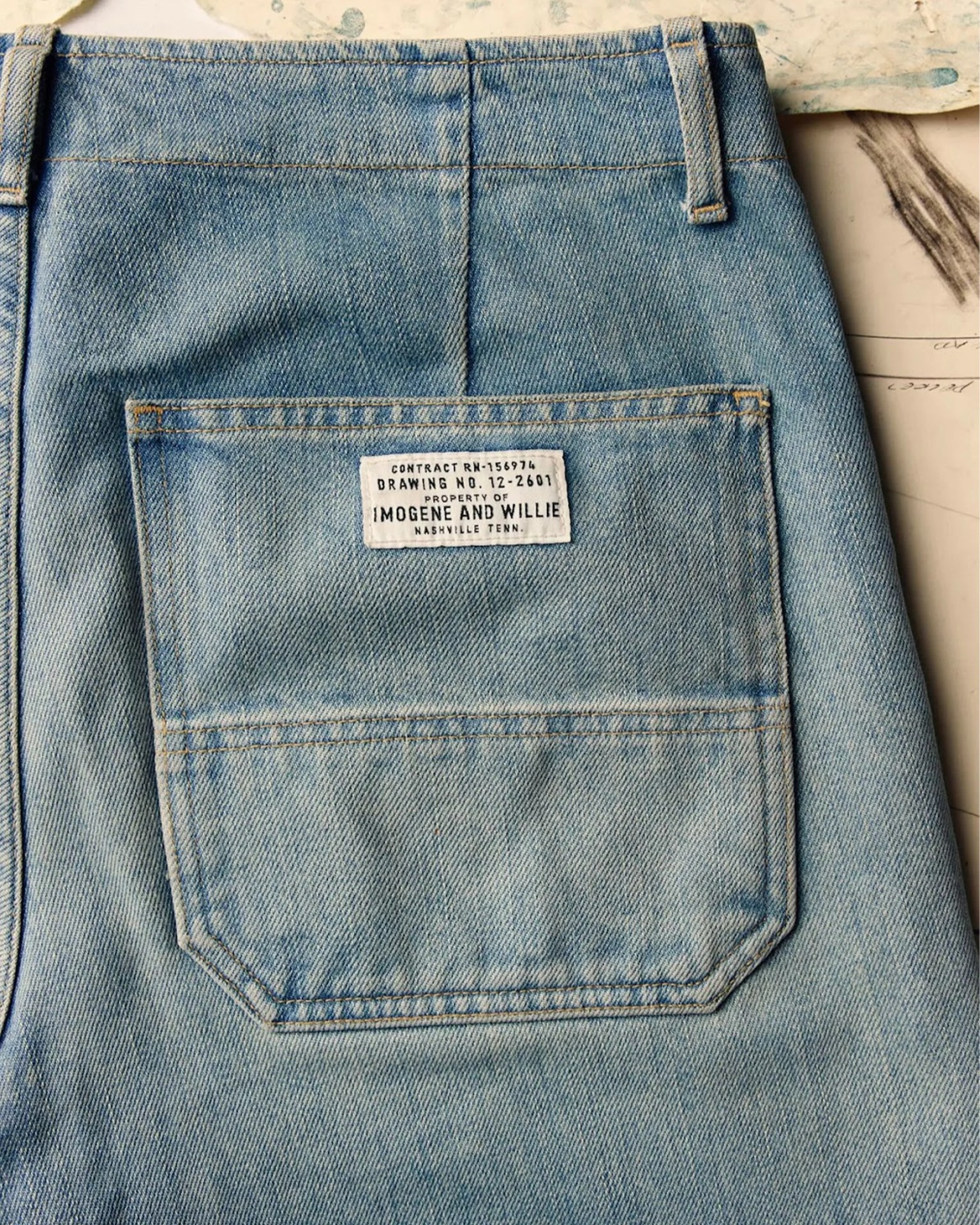 Light blue denim jeans back pocket with a white label reading "IMOGENE AND WILLIE NASHVILLE TENN.
