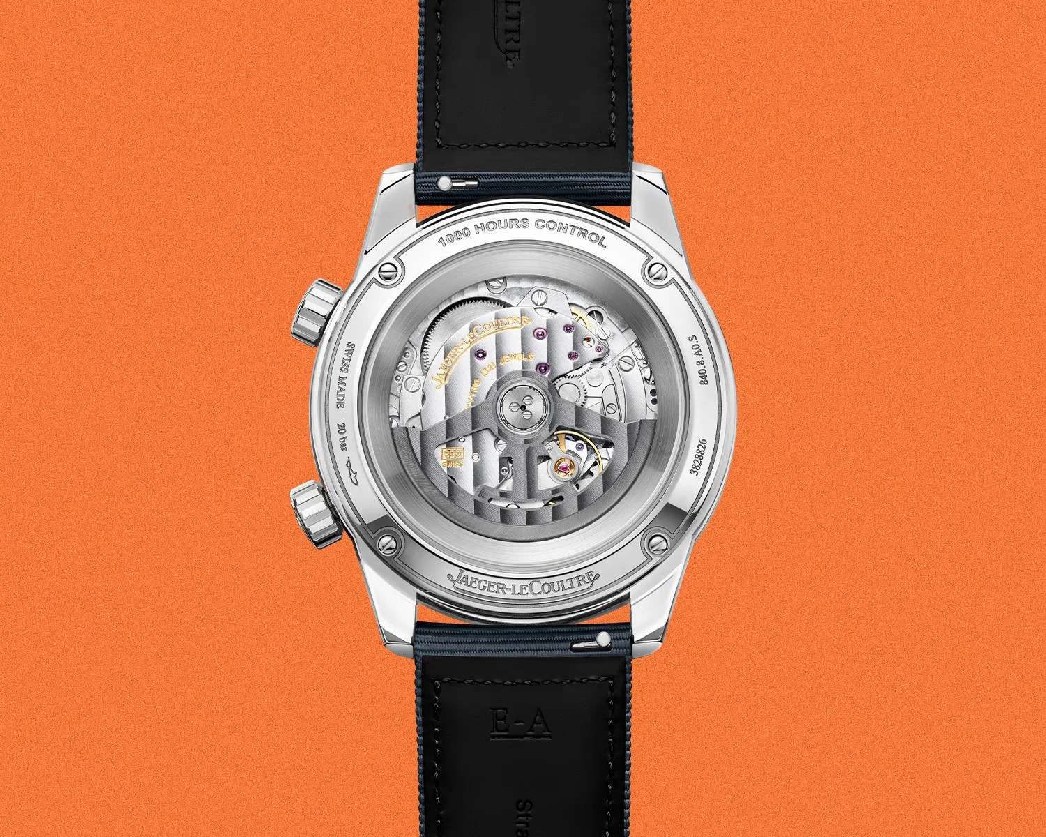 Back view of a Jaeger-LeCoultre watch with visible mechanical movement and black leather strap on an orange background.