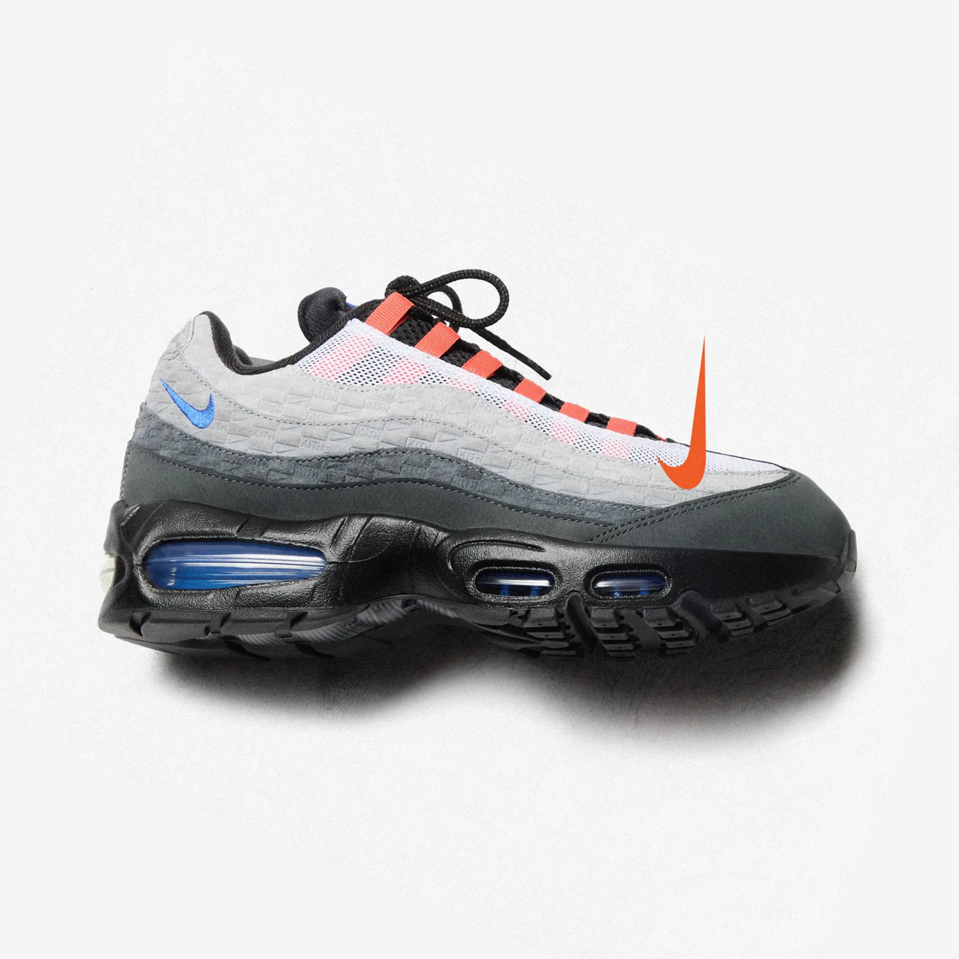 Gray and black Nike Air Max sneaker with orange accents and blue air cushion in sole.
