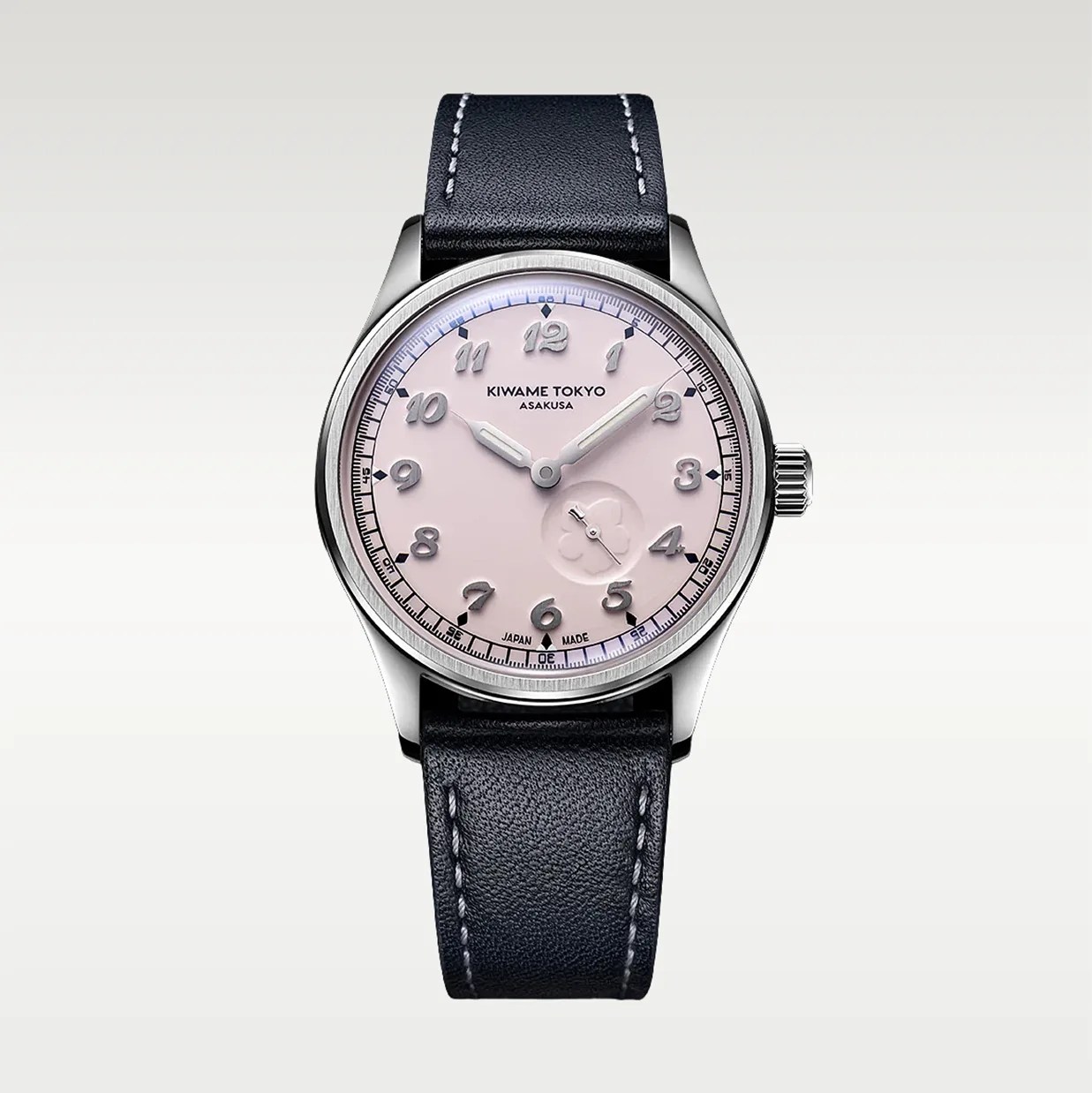 Silver wristwatch with a pale pink dial, raised silver numerals, and a black leather strap with white stitching.