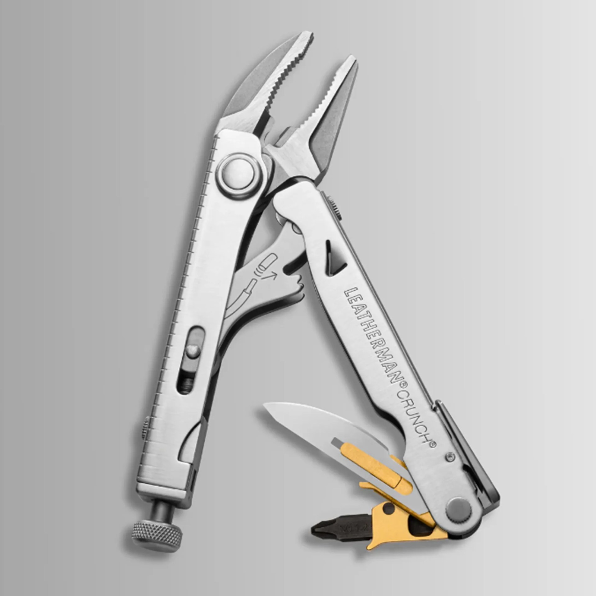 Silver Leatherman Crunch multi-tool with pliers, knife blade, and gold-colored bit driver on a gray background.