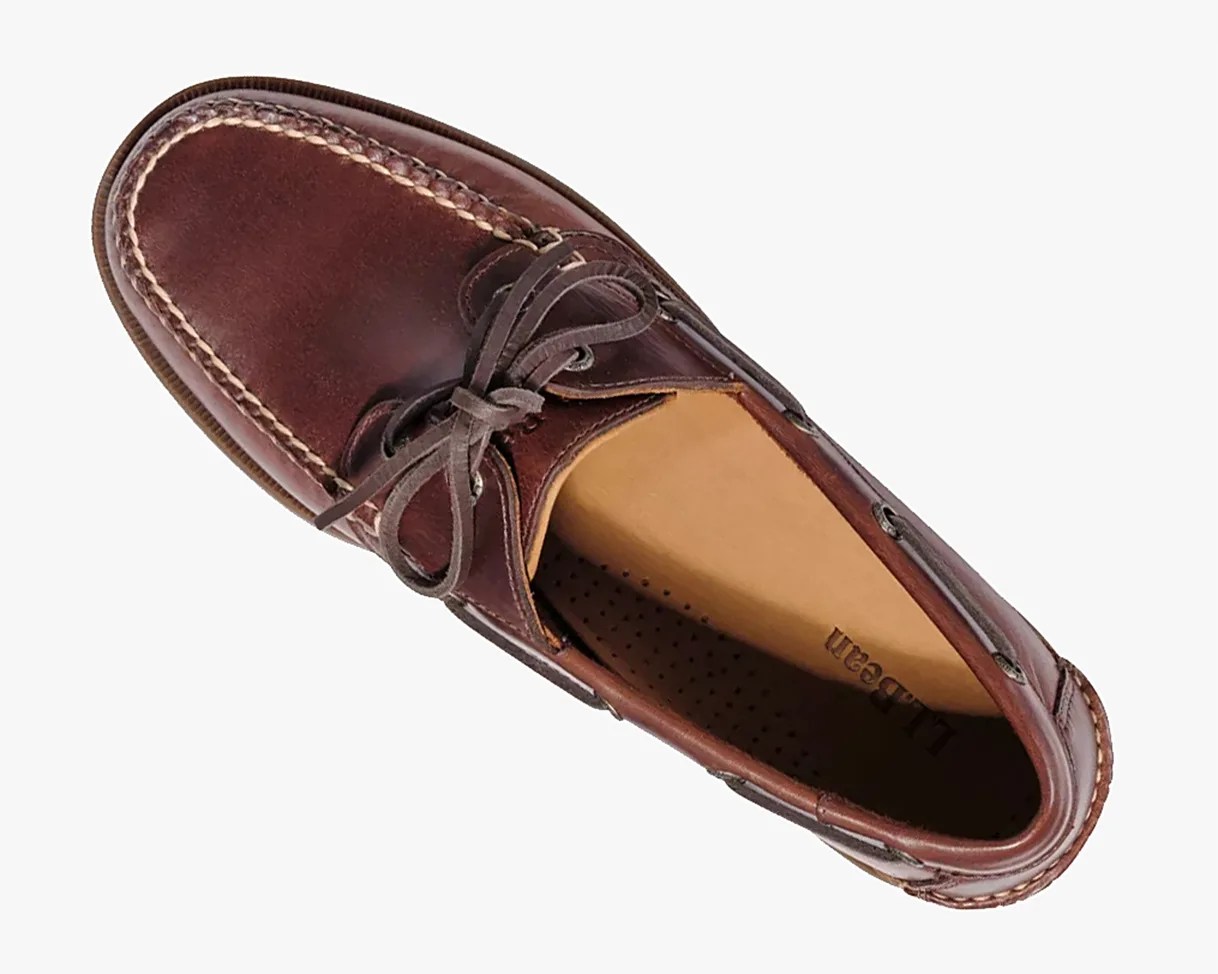 Brown leather boat shoe with moc toe stitching and tied laces, viewed from above.