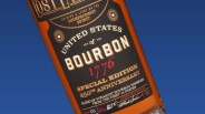 Close-up of a bourbon bottle label reading "United States of Bourbon 1776 Special Edition 250th Anniversary" with black, gold, and red text on a black background.