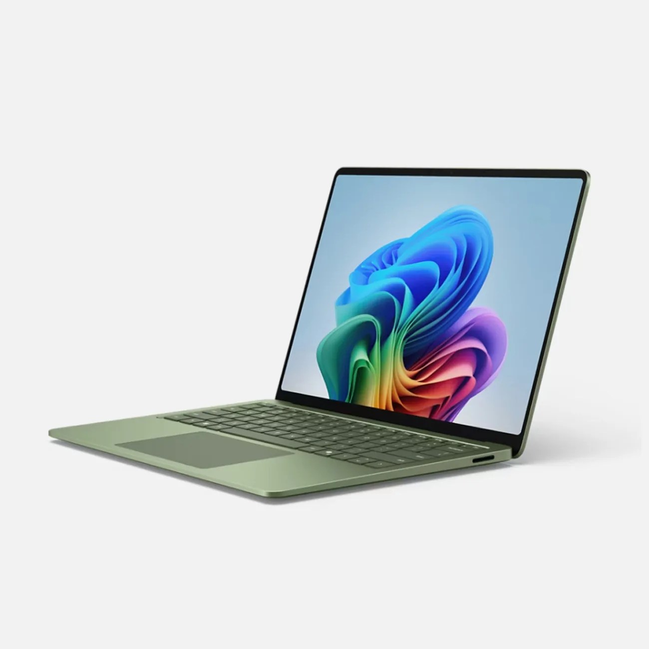 Slim green laptop with colorful abstract wallpaper on screen, shown at a slight angle on a white background.