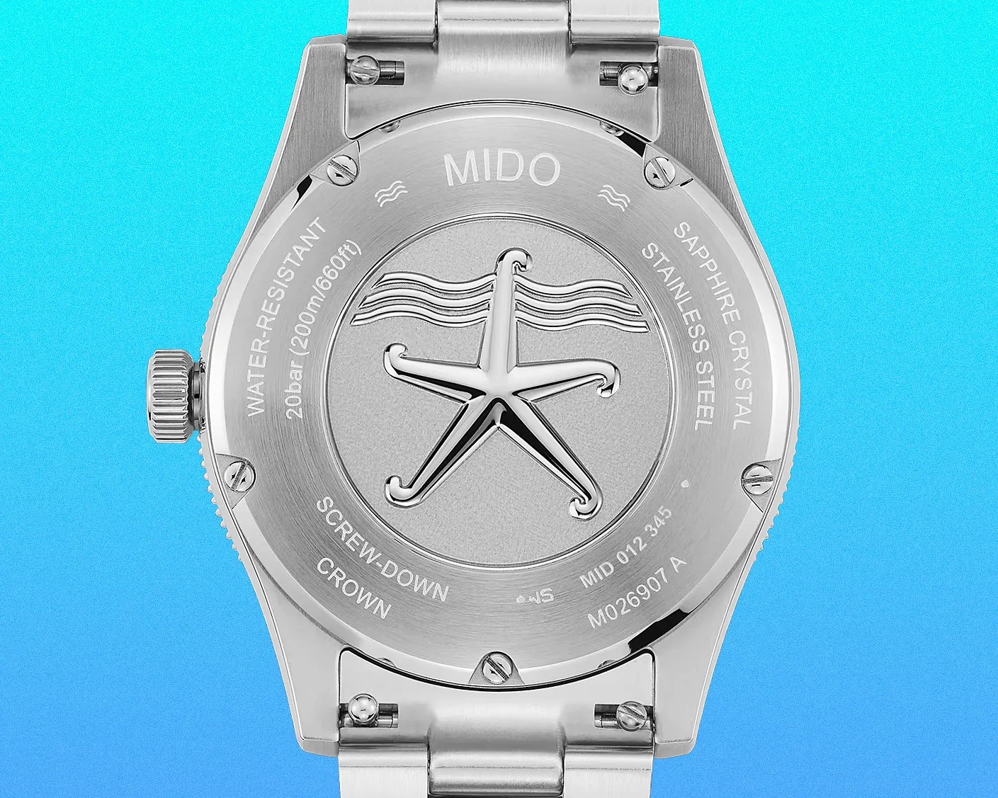 Brushed stainless steel watch back with engraved starfish and water resistance details on a blue gradient background.