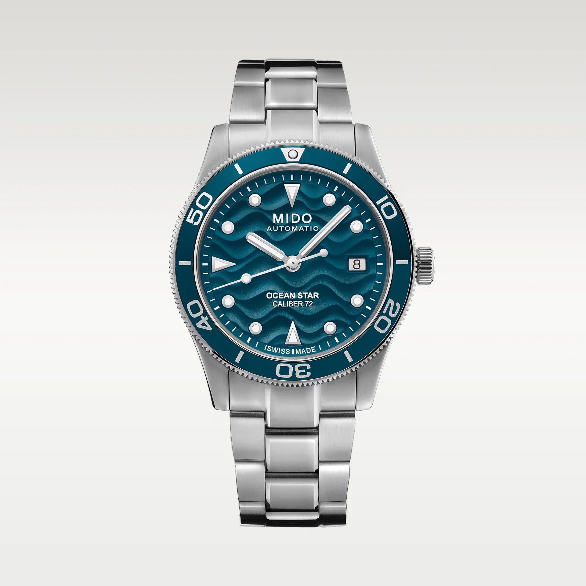 Stainless steel Mido Ocean Star Caliber 72 automatic watch with blue wave-patterned dial and date window.