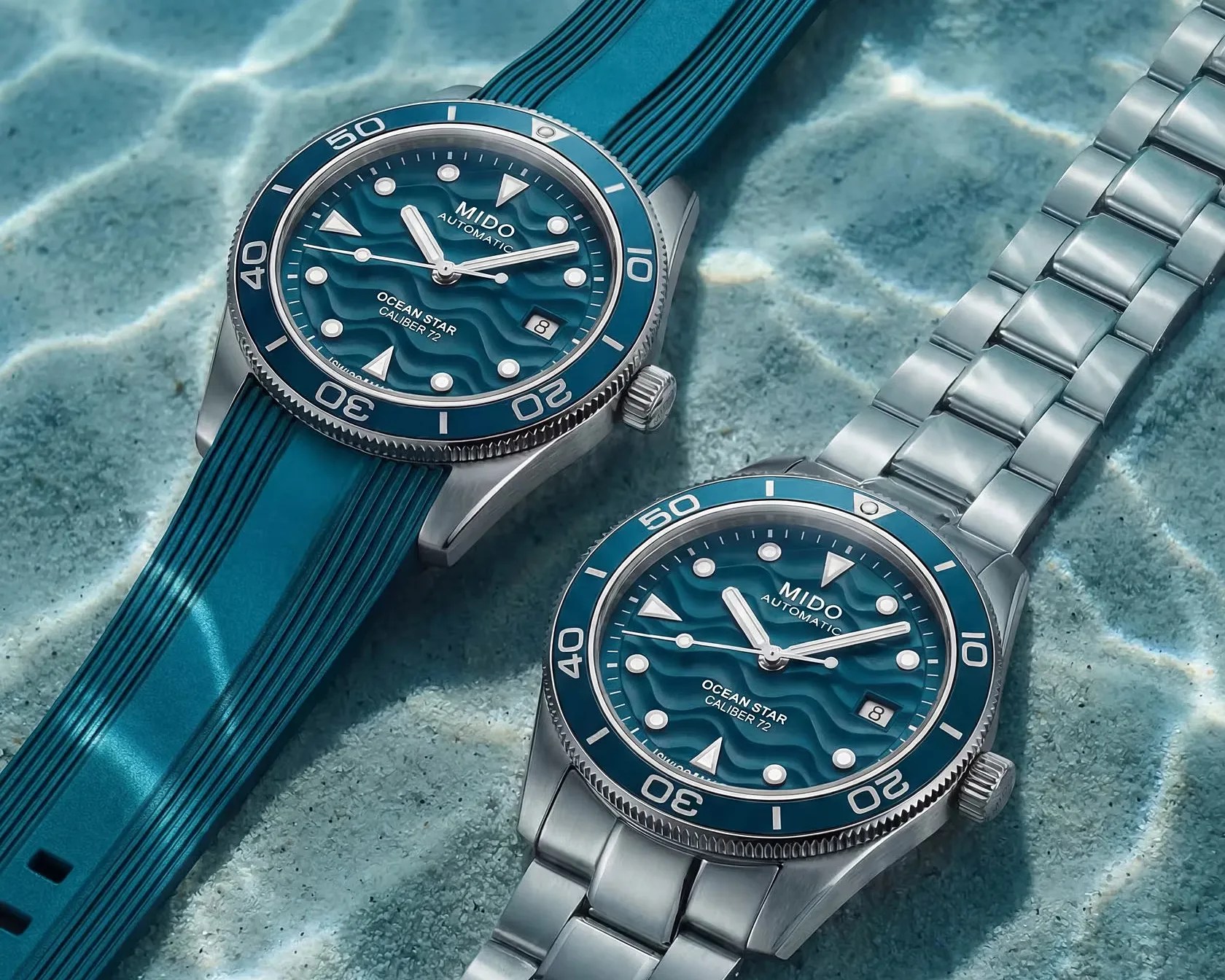 Two Mido Ocean Star Caliber 72 automatic watches with blue wave-patterned dials, one with a blue rubber strap and the other with a silver metal bracelet.
