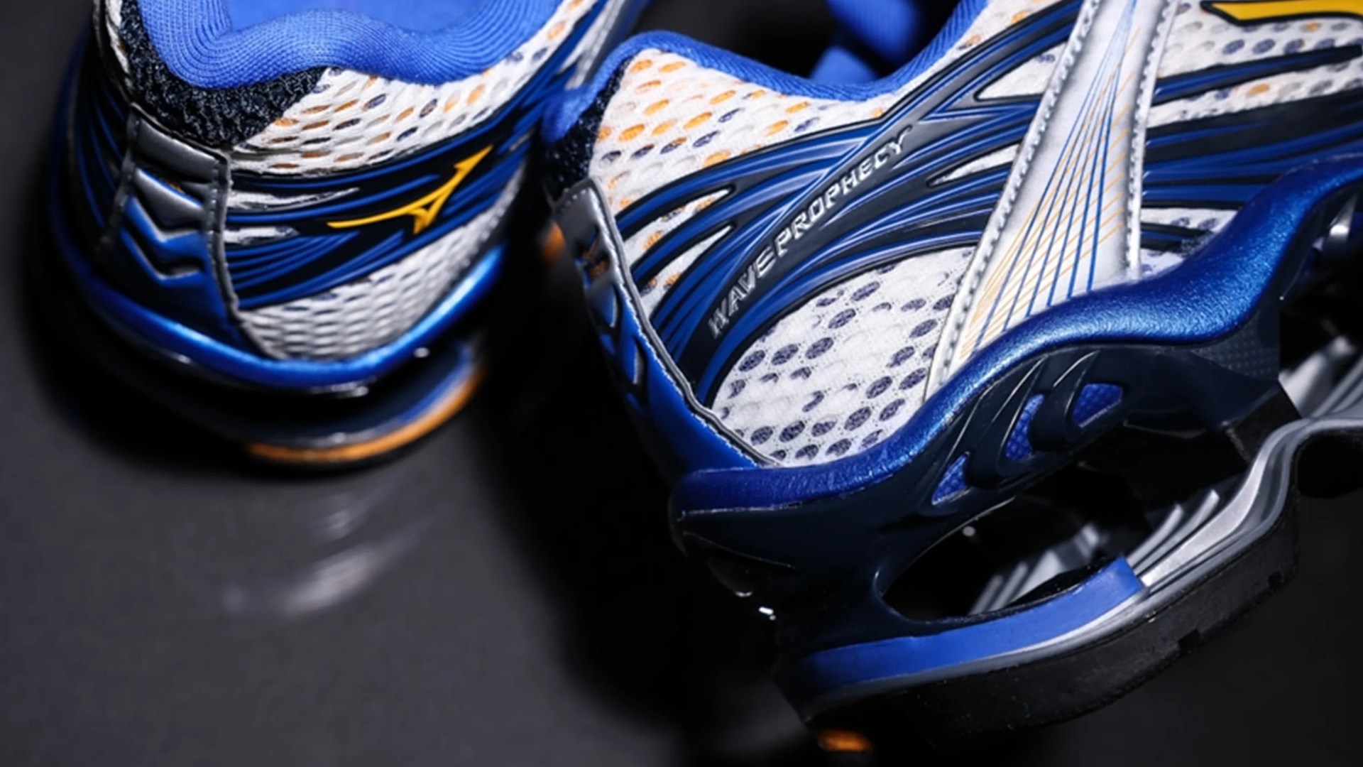 Pair of blue and white Mizuno Wave Prophecy running shoes with mesh uppers and cushioned soles.