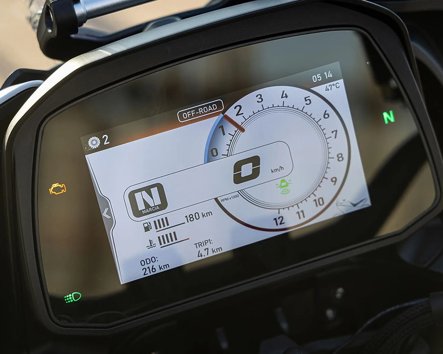 Motorcycle digital dashboard showing off-road mode, neutral gear, 0 km/h speed, 216 km odometer, and 47°C temperature.