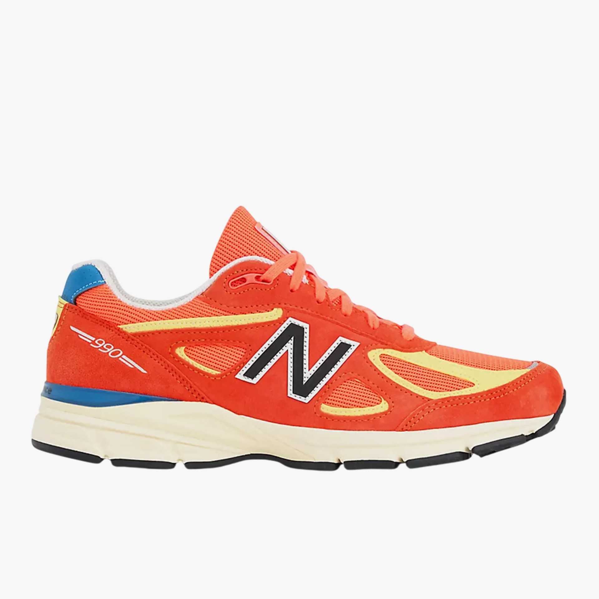 Orange and yellow New Balance 990v3 sneaker with blue heel tab and white sole.