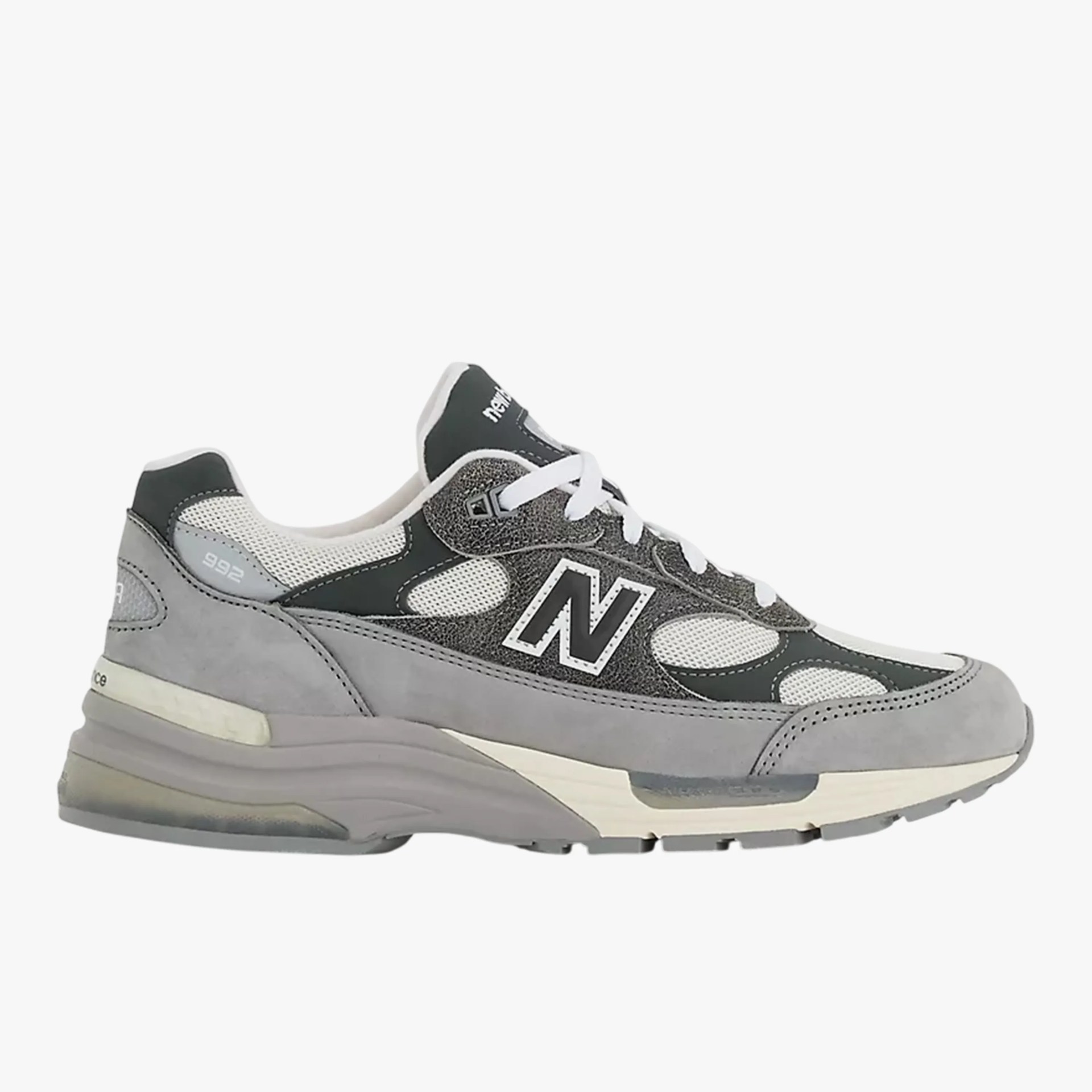 Gray and white New Balance 992 sneaker with mesh and suede upper and white laces.