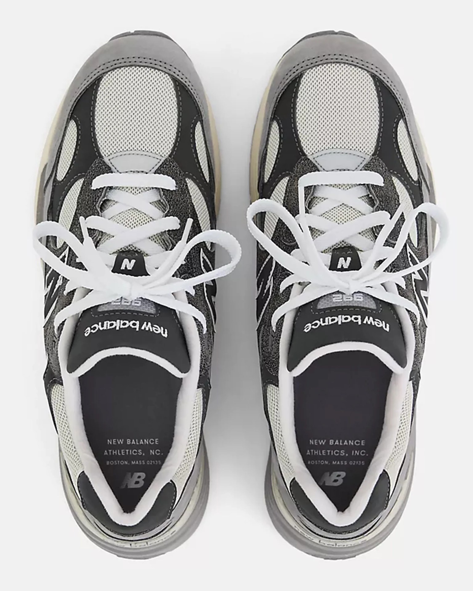 Pair of gray, black, and white New Balance 992 sneakers with white laces viewed from above.