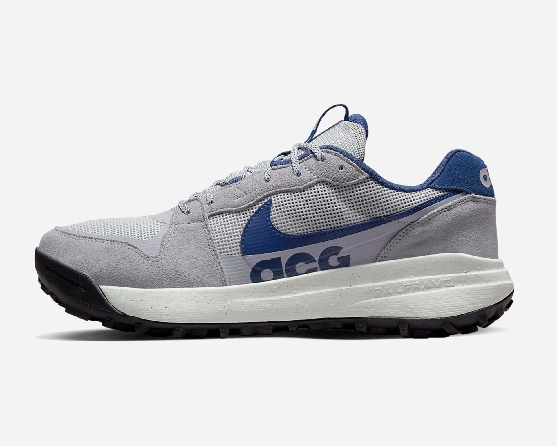 Gray and blue Nike ACG sneaker with mesh and suede upper and white sole with black tread.