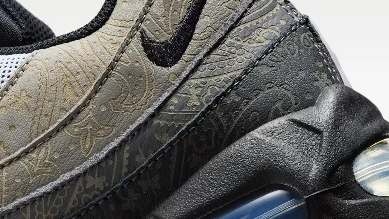 Close-up of a black and gray sneaker with paisley pattern detailing and a visible air cushion in the sole.