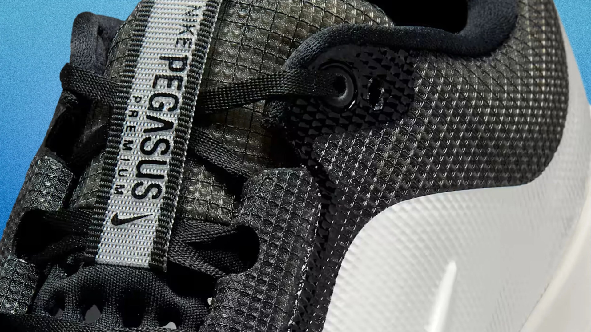 Close-up of a black Nike Pegasus Premium sneaker with textured upper and white midsole.