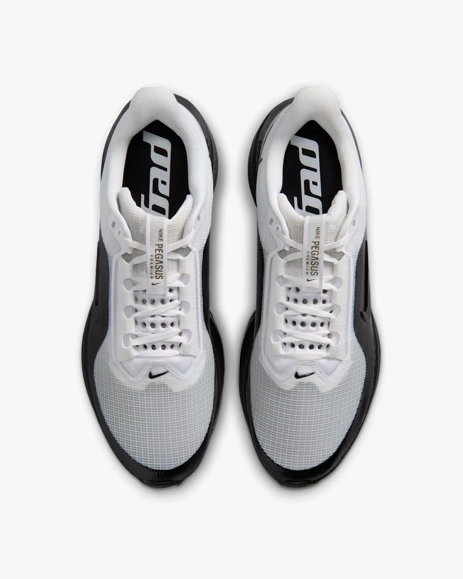 Pair of white and black Nike Pegasus Premium sneakers viewed from above.