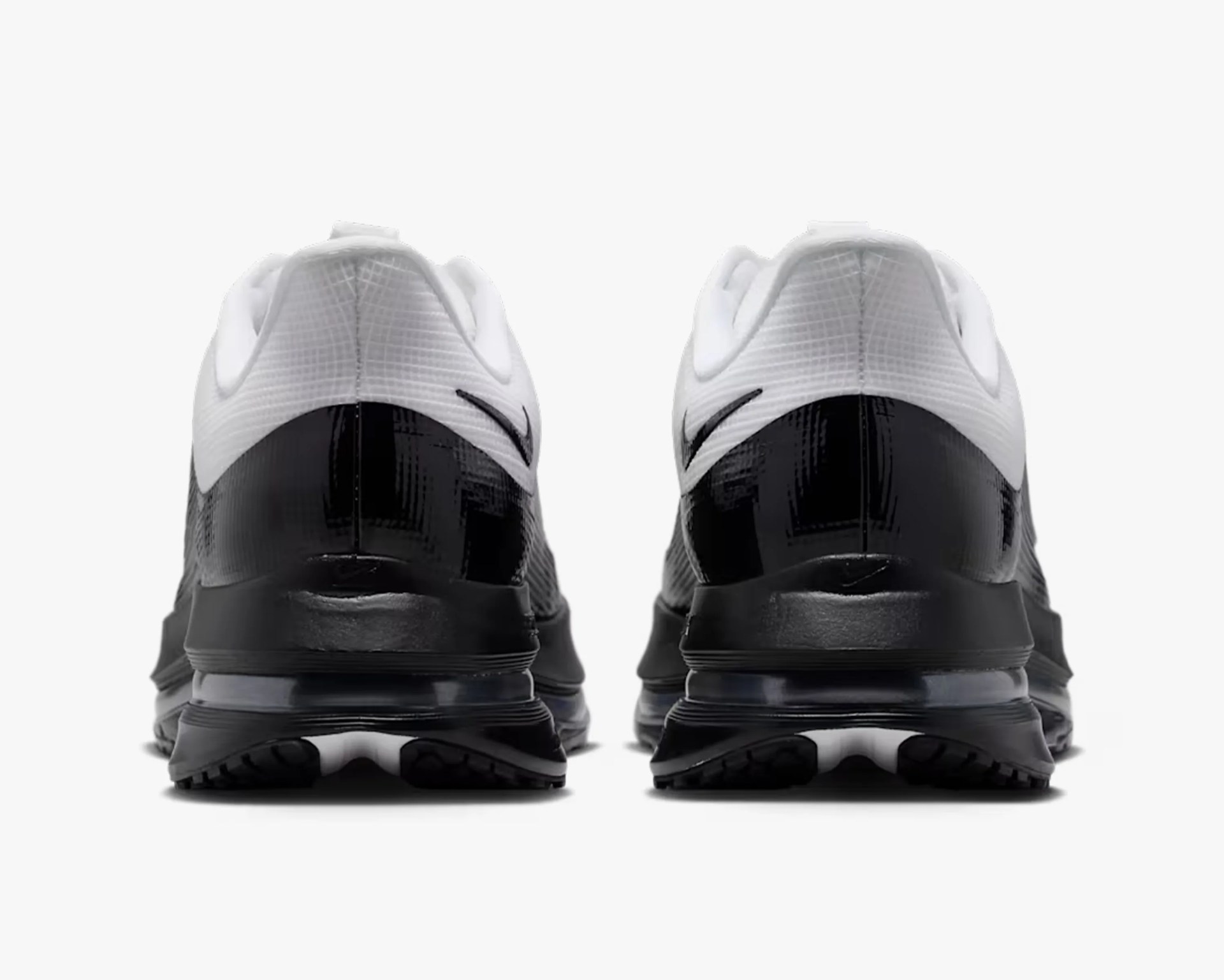 Pair of black and white Nike sneakers shown from the back with visible Nike swoosh logos on the heels.