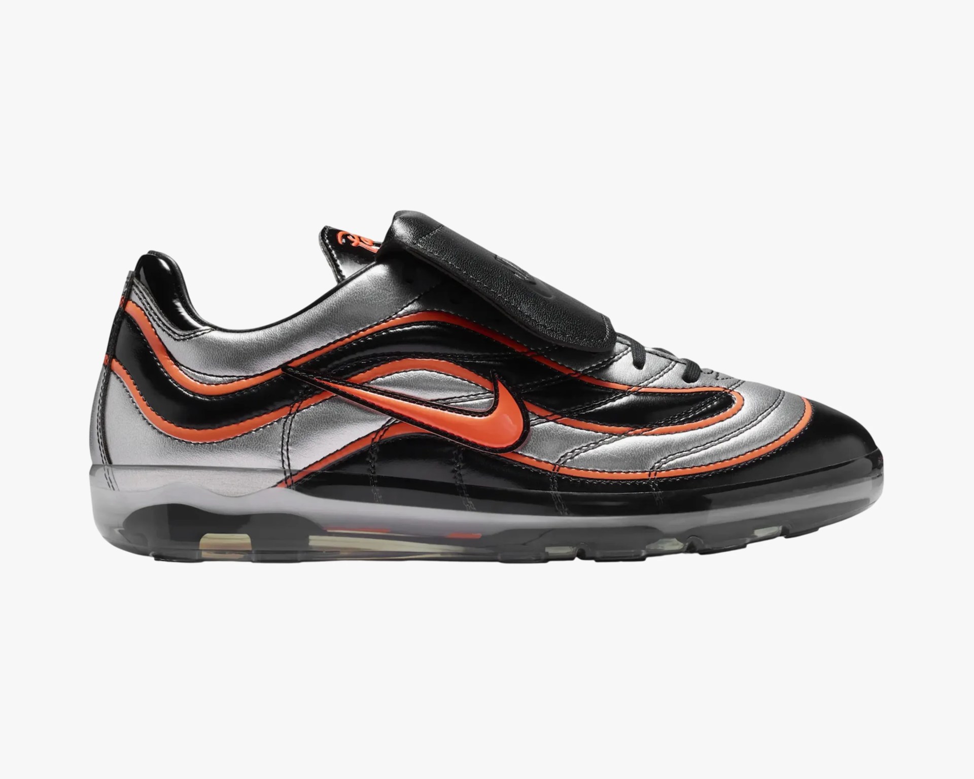 Black and silver Nike sneaker with orange accents and a transparent sole viewed from the side.