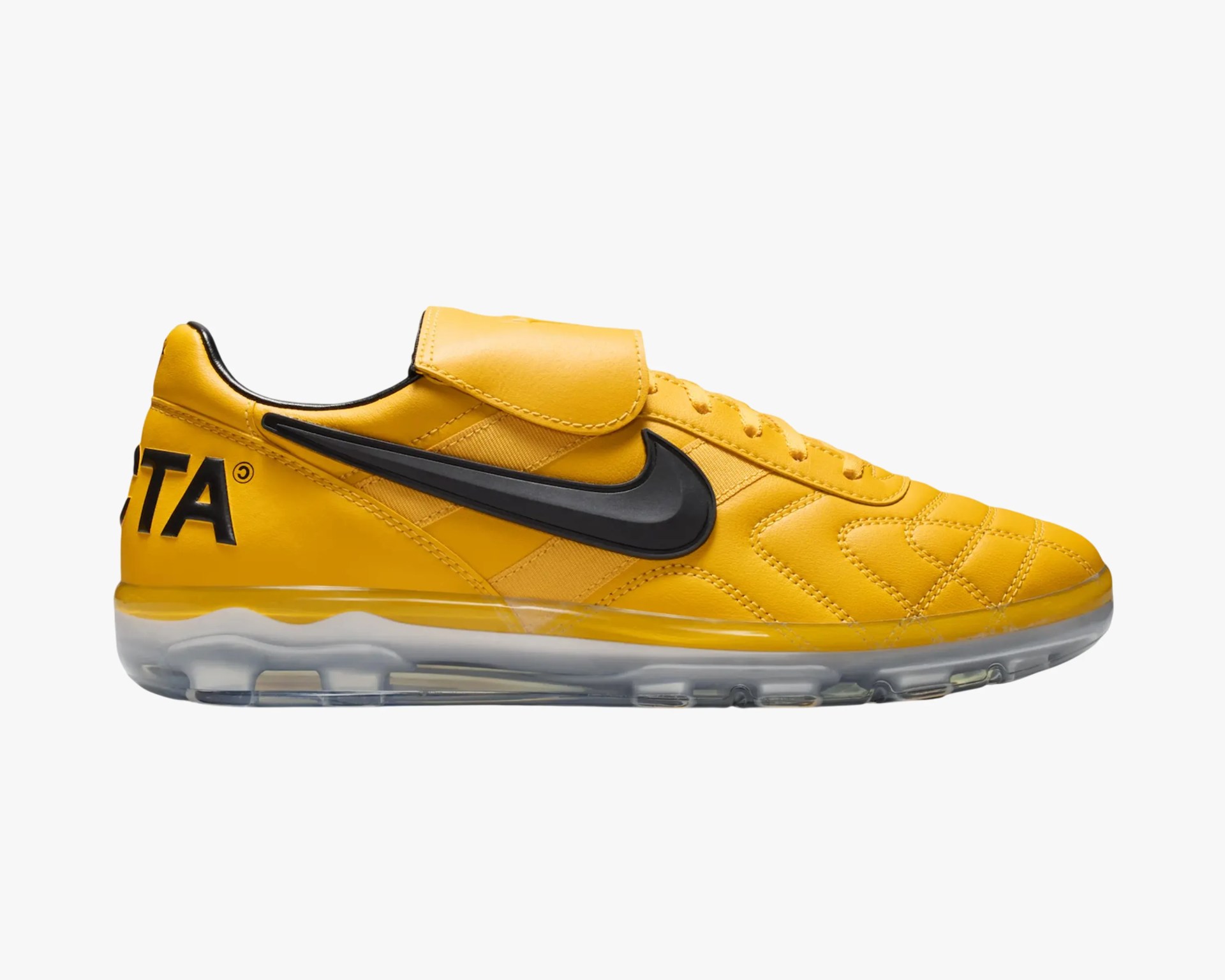 Yellow Nike sneaker with black swoosh logo, clear sole, and black text on the heel.