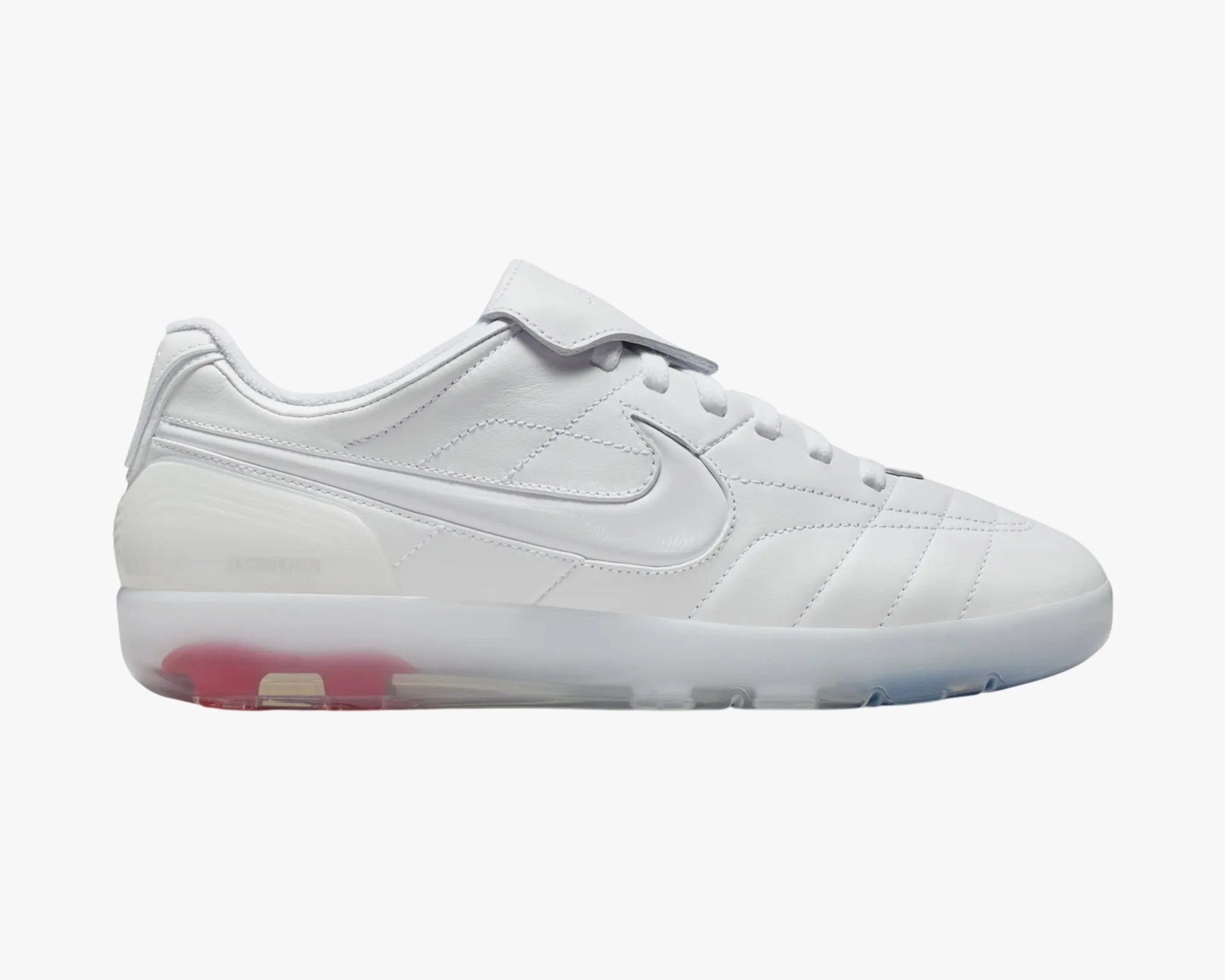 White leather Nike sneaker with a translucent sole featuring red and blue accents.