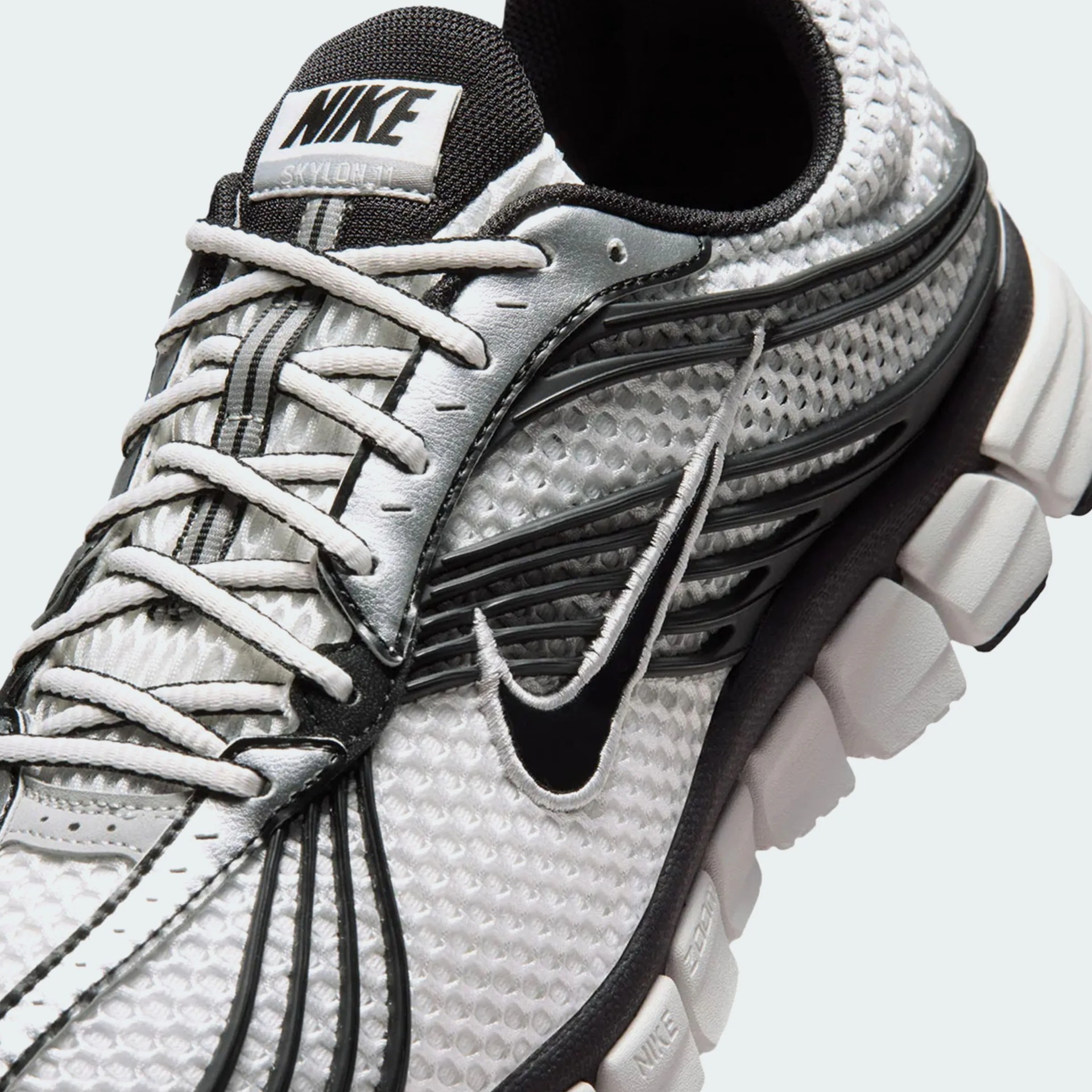 Close-up of a white and black Nike Skylon II sneaker with mesh upper and detailed lacing.