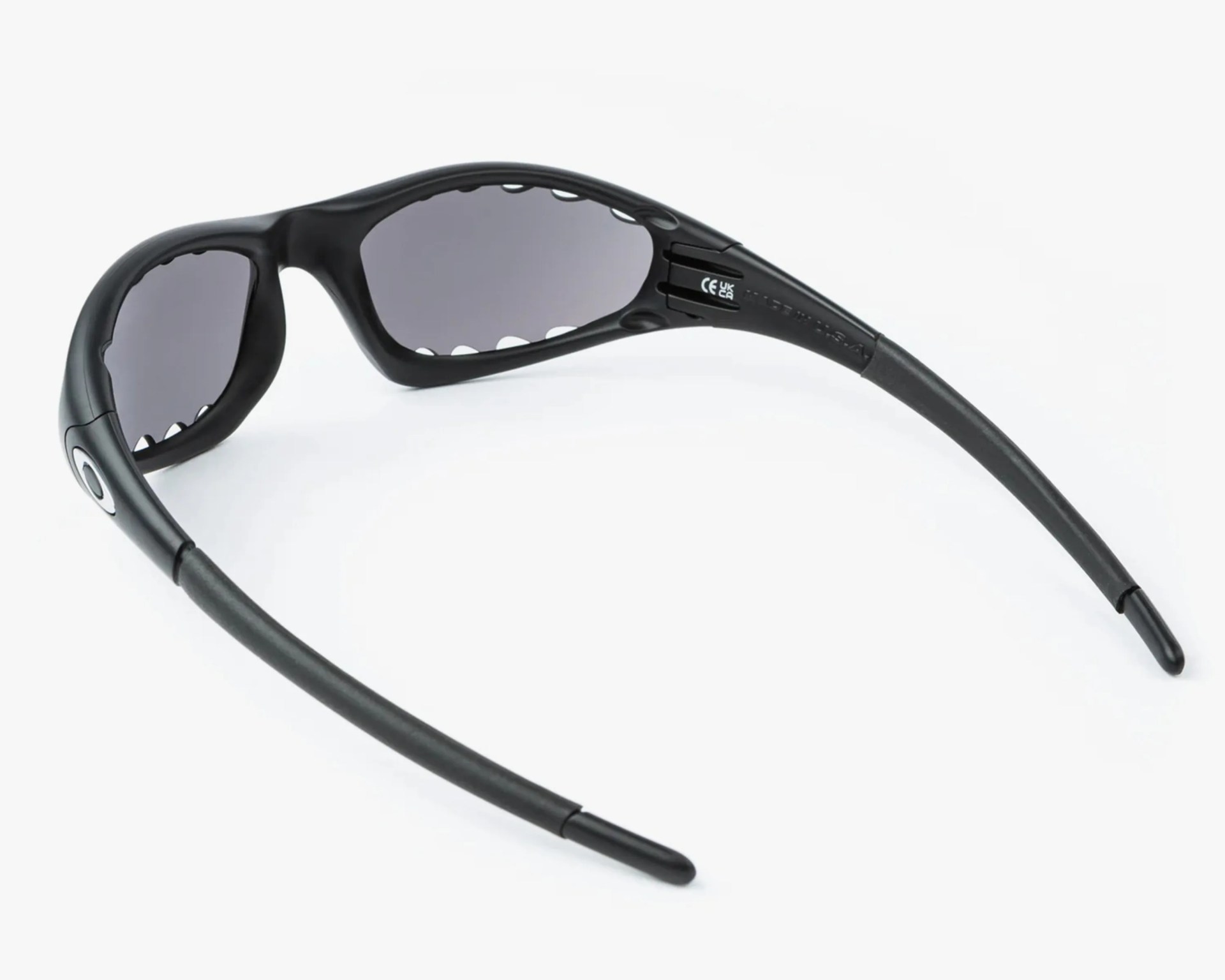 Black wraparound sunglasses with dark lenses and a curved frame shown from the back.