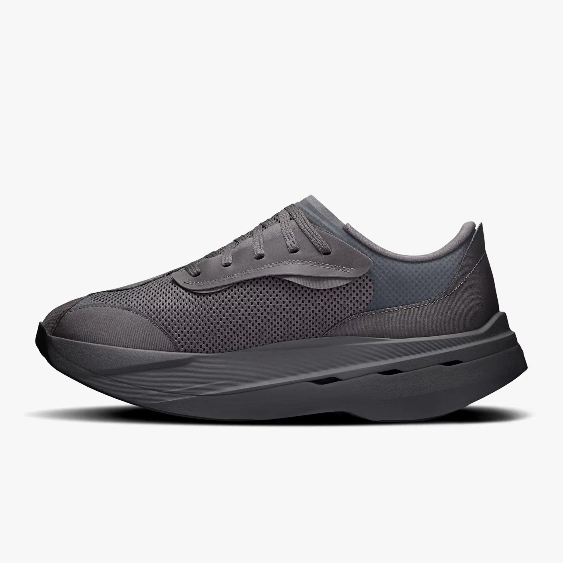 Dark gray athletic shoe with mesh upper and thick cushioned sole.