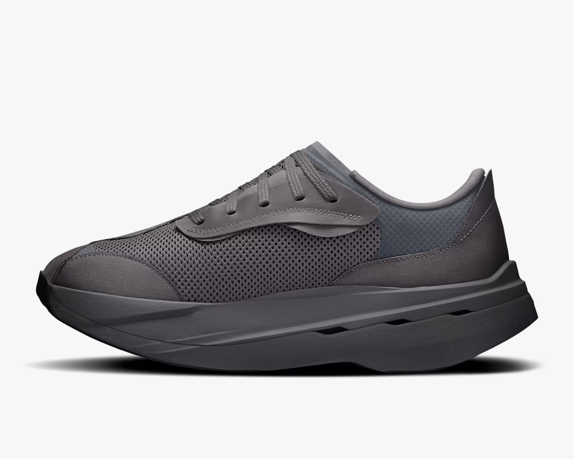 Dark gray athletic sneaker with mesh upper and thick cushioned sole.