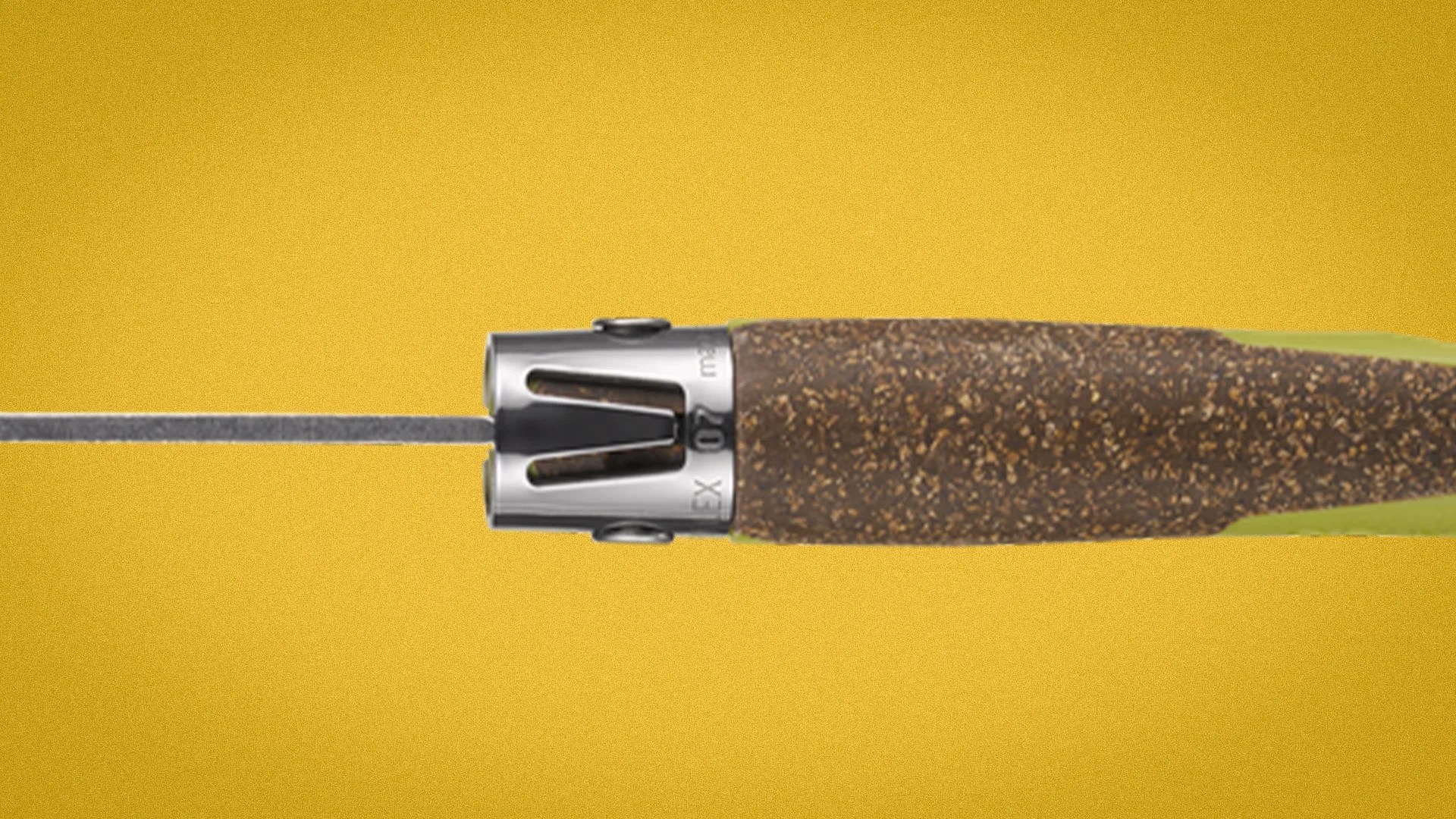 Close-up of a knife handle with a cork grip and a metal bolster on a yellow background.