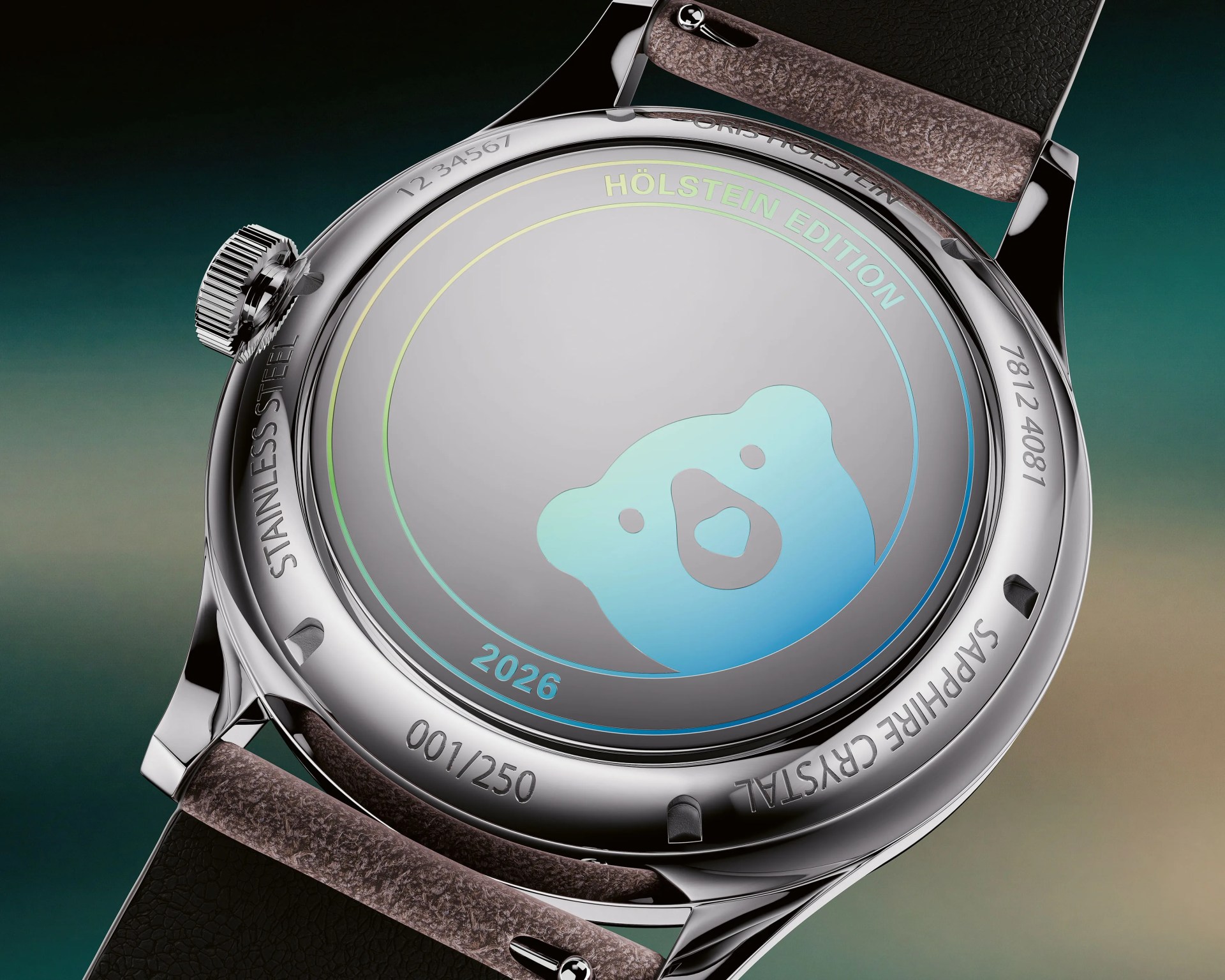 Close-up of a stainless steel watch back with "Hölstein Edition 2026" and a blue bear graphic, brown leather strap attached.