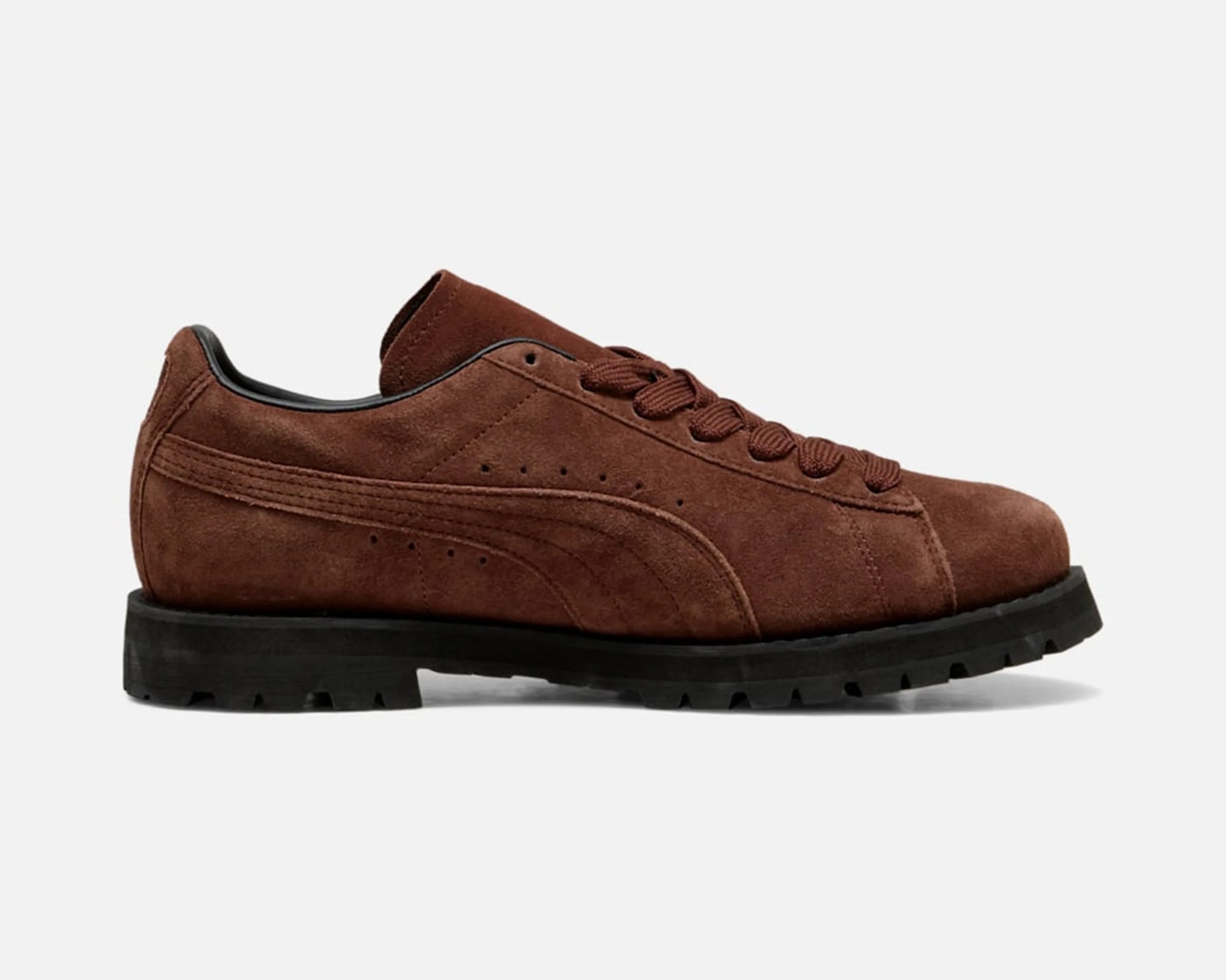 Brown suede lace-up shoe with black thick rubber sole on a white background.