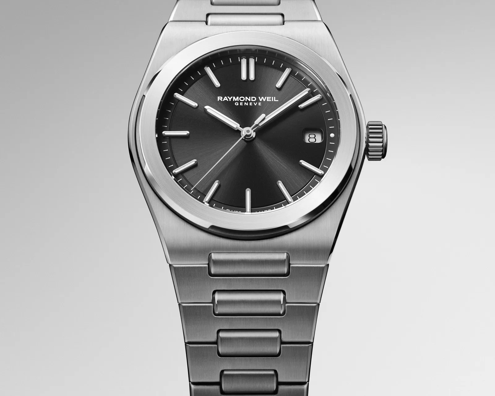 Stainless steel Raymond Weil wristwatch with black dial, silver hour markers, and date window at 3 o'clock.