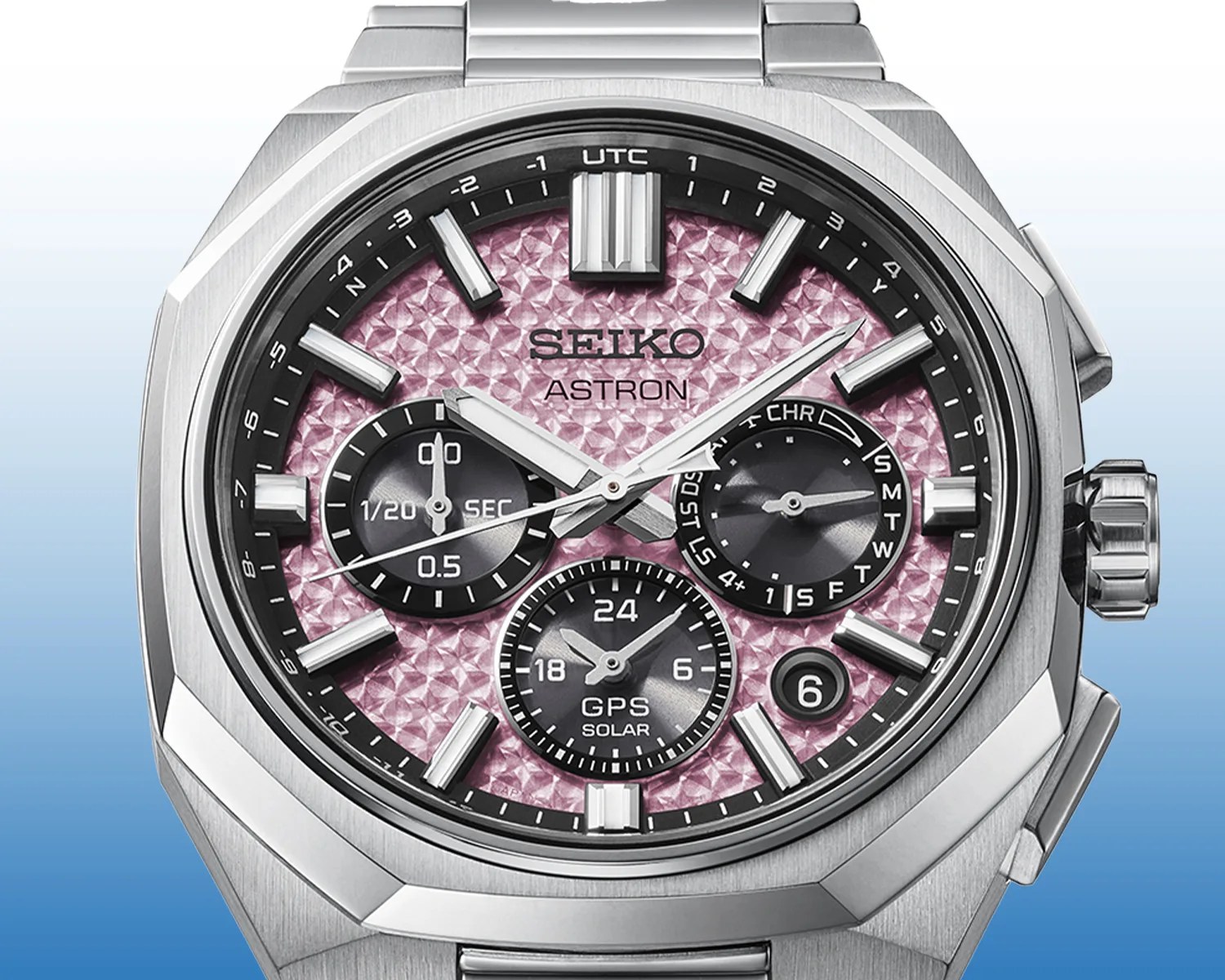 Seiko Astron GPS Solar watch with textured pink dial, three black subdials, and stainless steel case and bracelet.