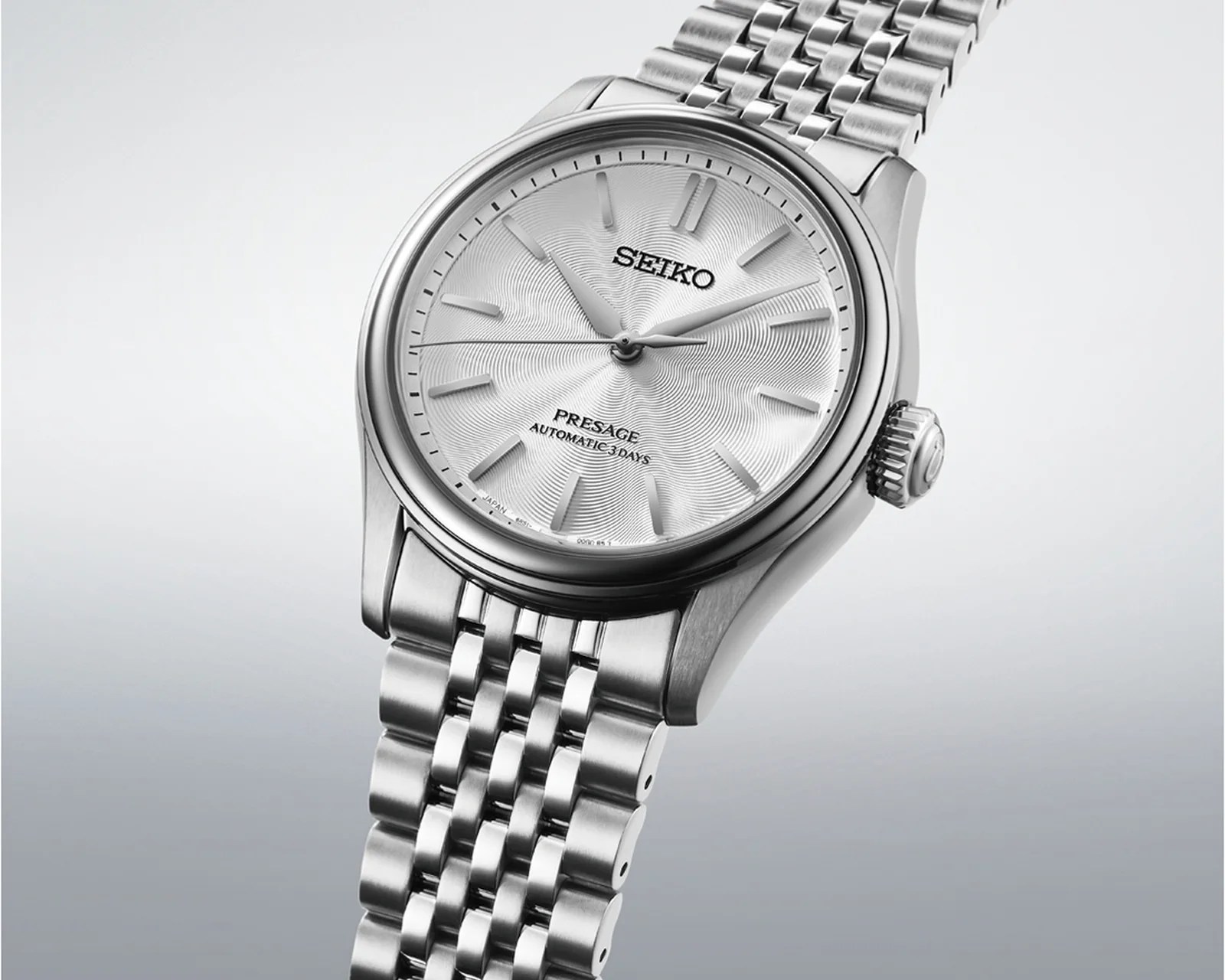 Silver Seiko Presage automatic wristwatch with textured dial and metal link bracelet.