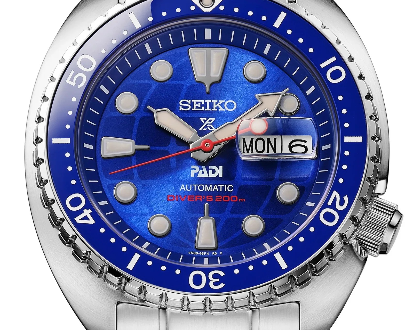 Close-up of a Seiko Prospex PADI automatic diver's watch with a blue dial, silver markers, and a date window showing Monday the 6th.
